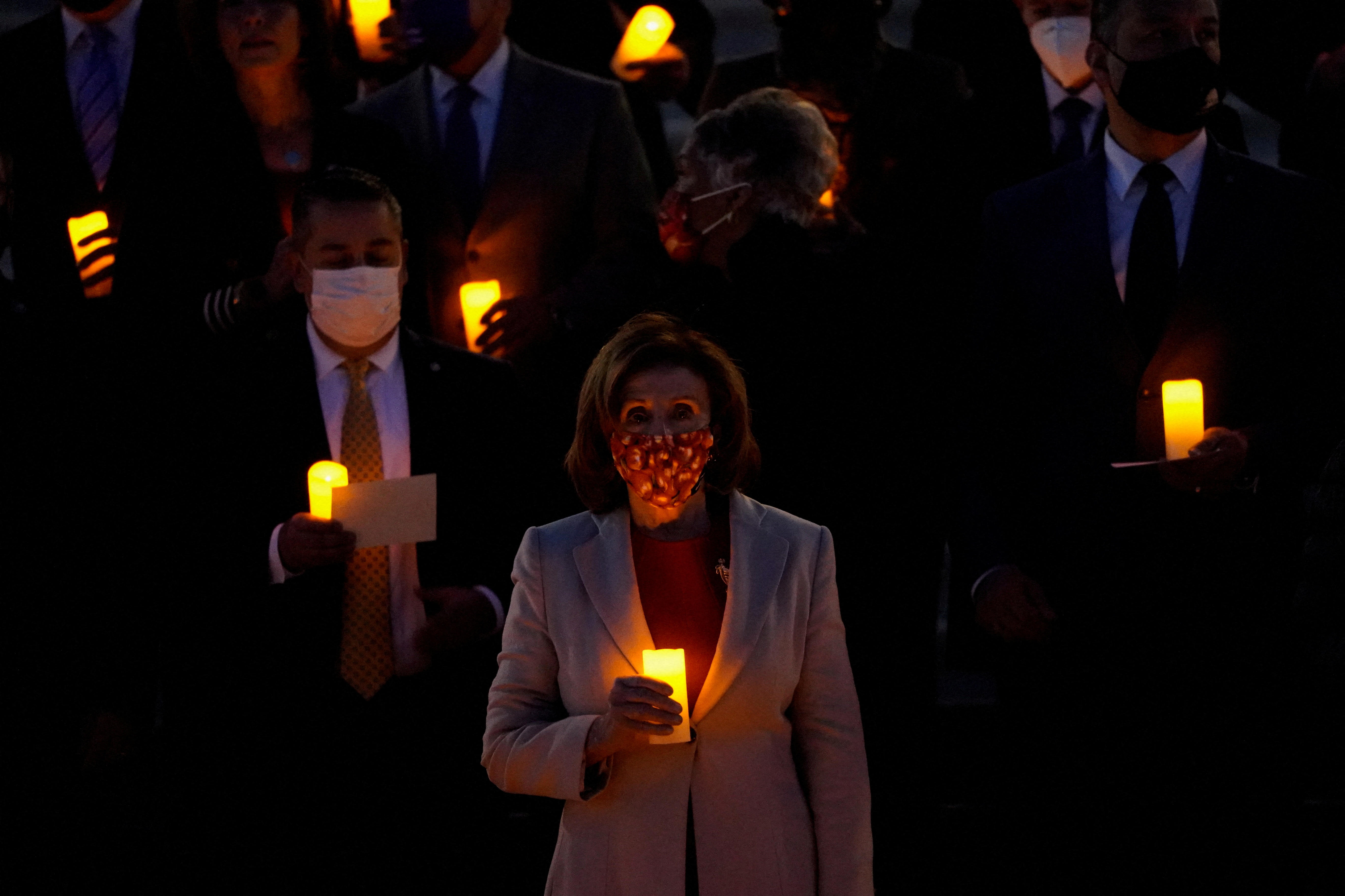 Bipartisan members of the House and Senate hold a moment of silence for the more than 800,000 American lives lost to COVID-19 outside the U.S. Capitol building in Washington