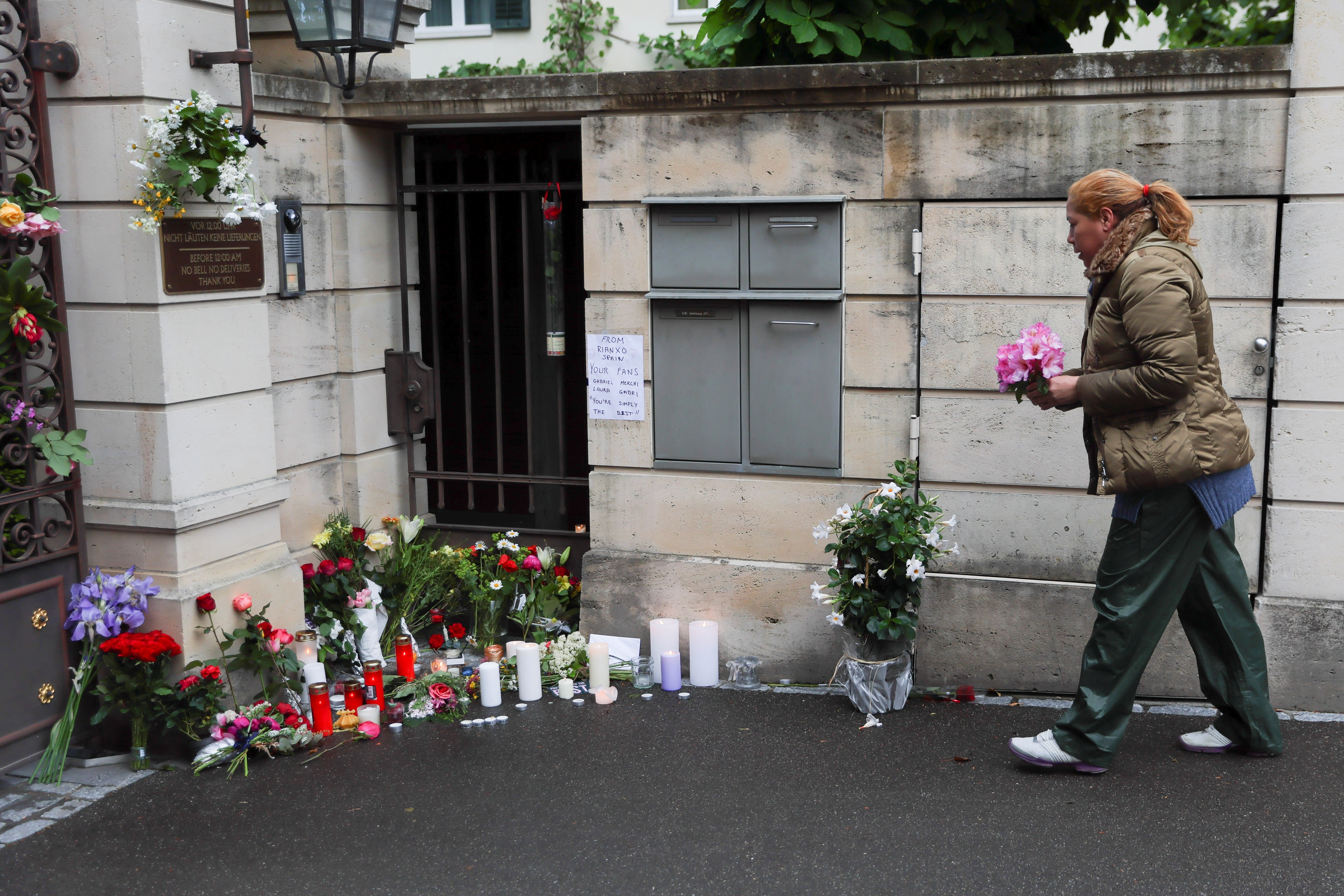 People lay flowers and candles in front of the home of late singer Tina Turner in Kuesnacht