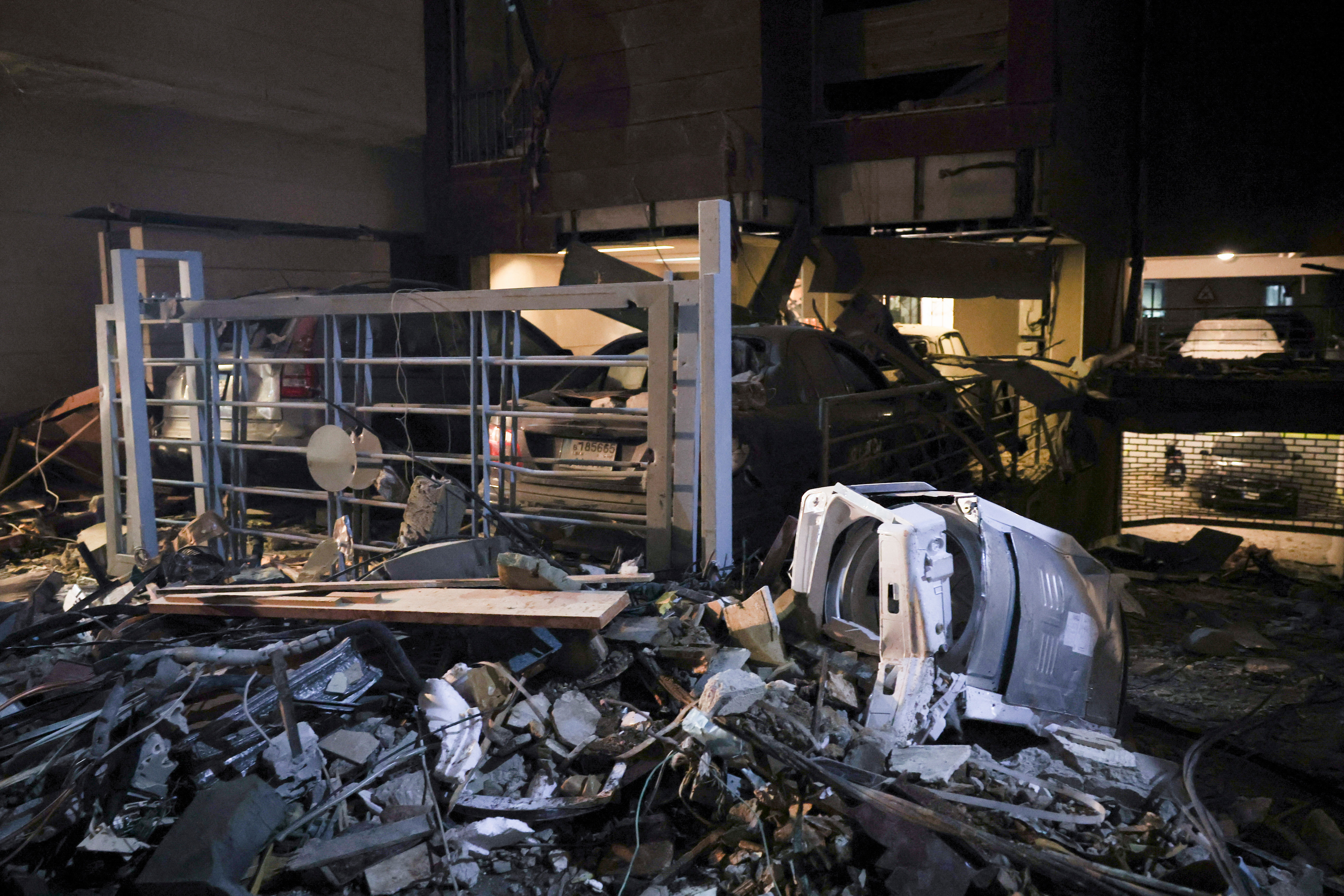 Debris lies on the ground near damaged vehicles at the site of an Israeli air strike, in Beirut