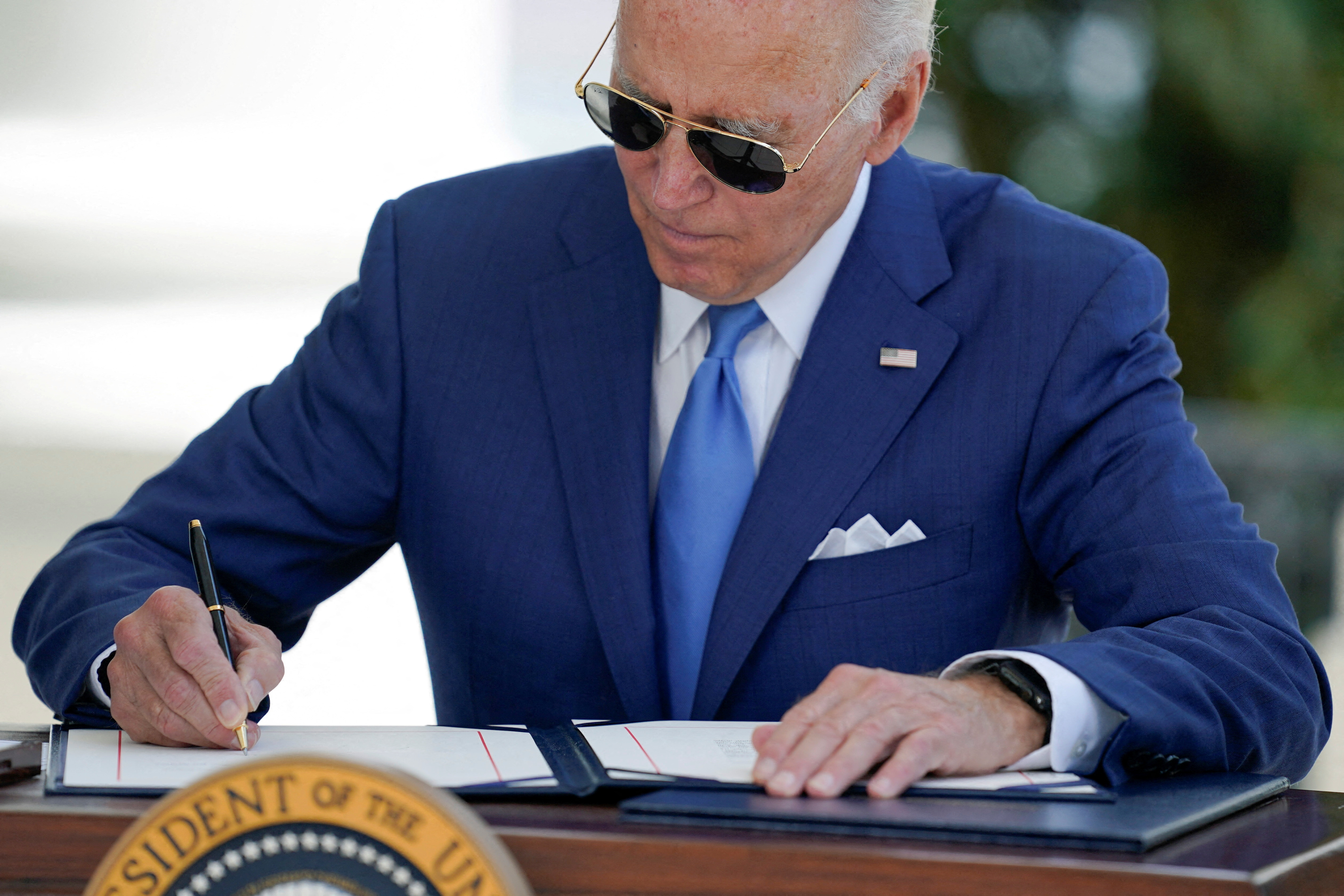 U.S President Joe Biden signs two bills aimed at combating fraud in the COVID-19 small business relief programs in Washington