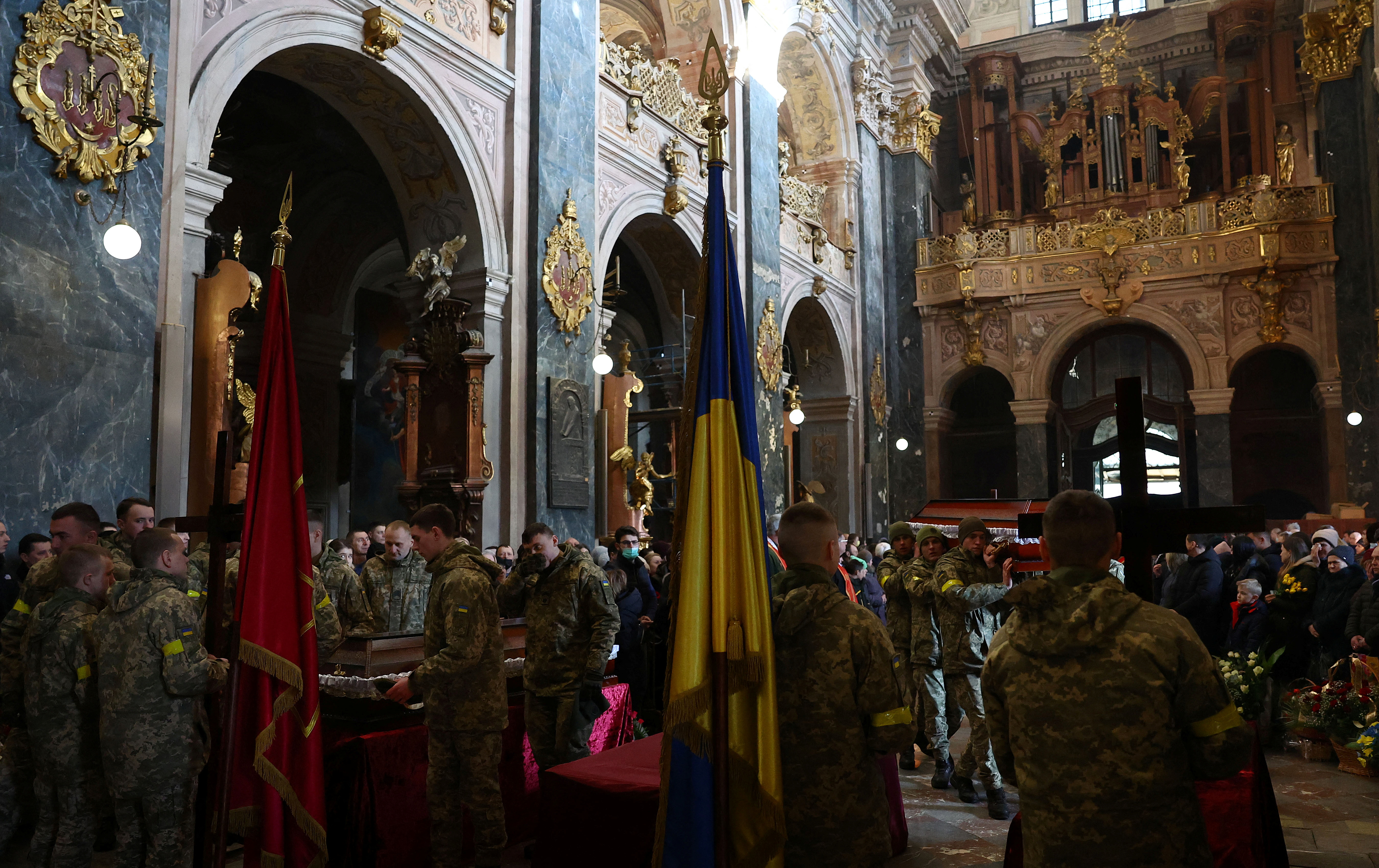 People attend the memorial and funeral service for three fallen Ukrainian Army service men in Lviv
