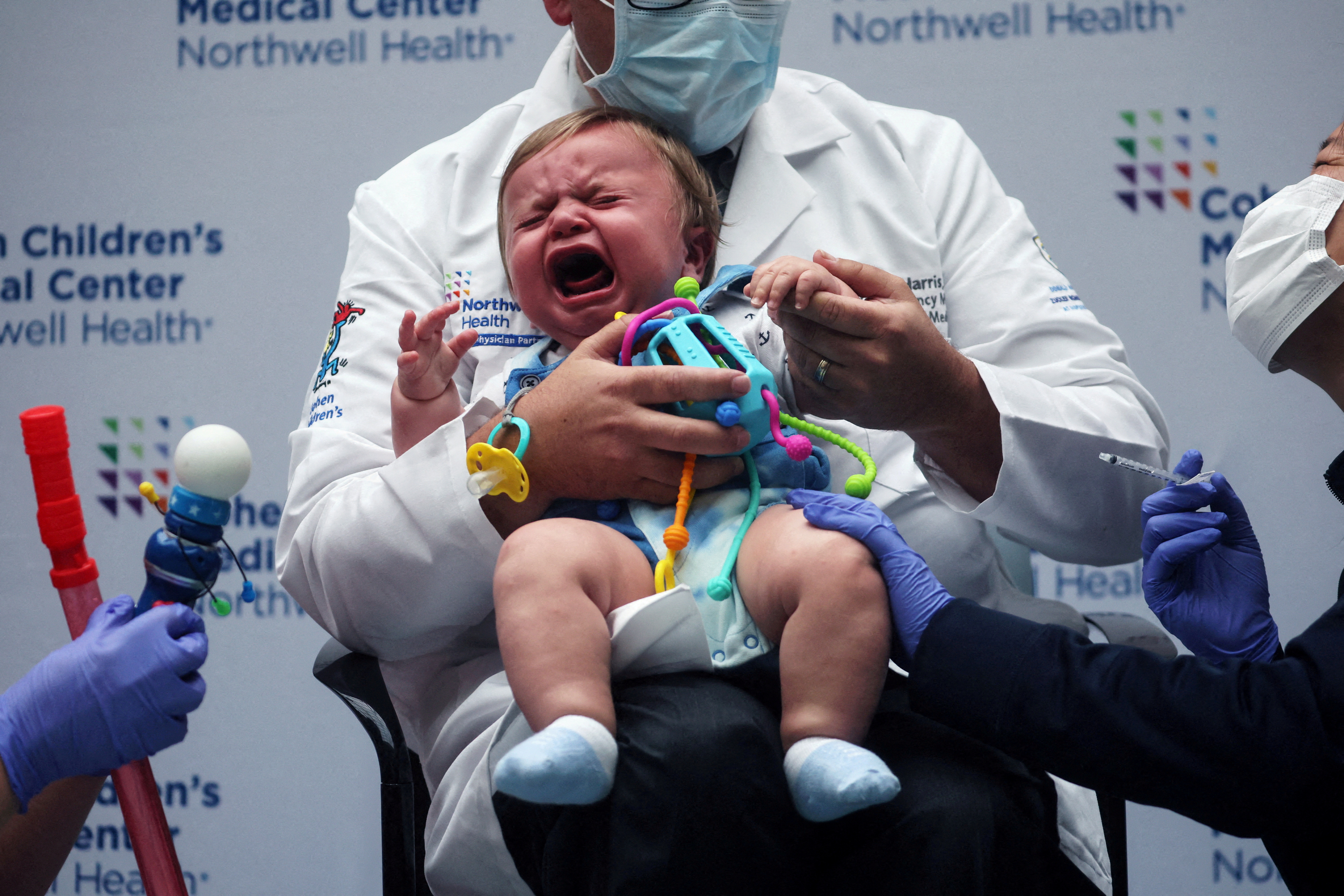 Oliver Harris, 9 months, cries after receiving a vaccine against the coronavirus disease (COVID-19) at Northwell Health's Cohen Children's Medical Center in New Hyde Park, New York