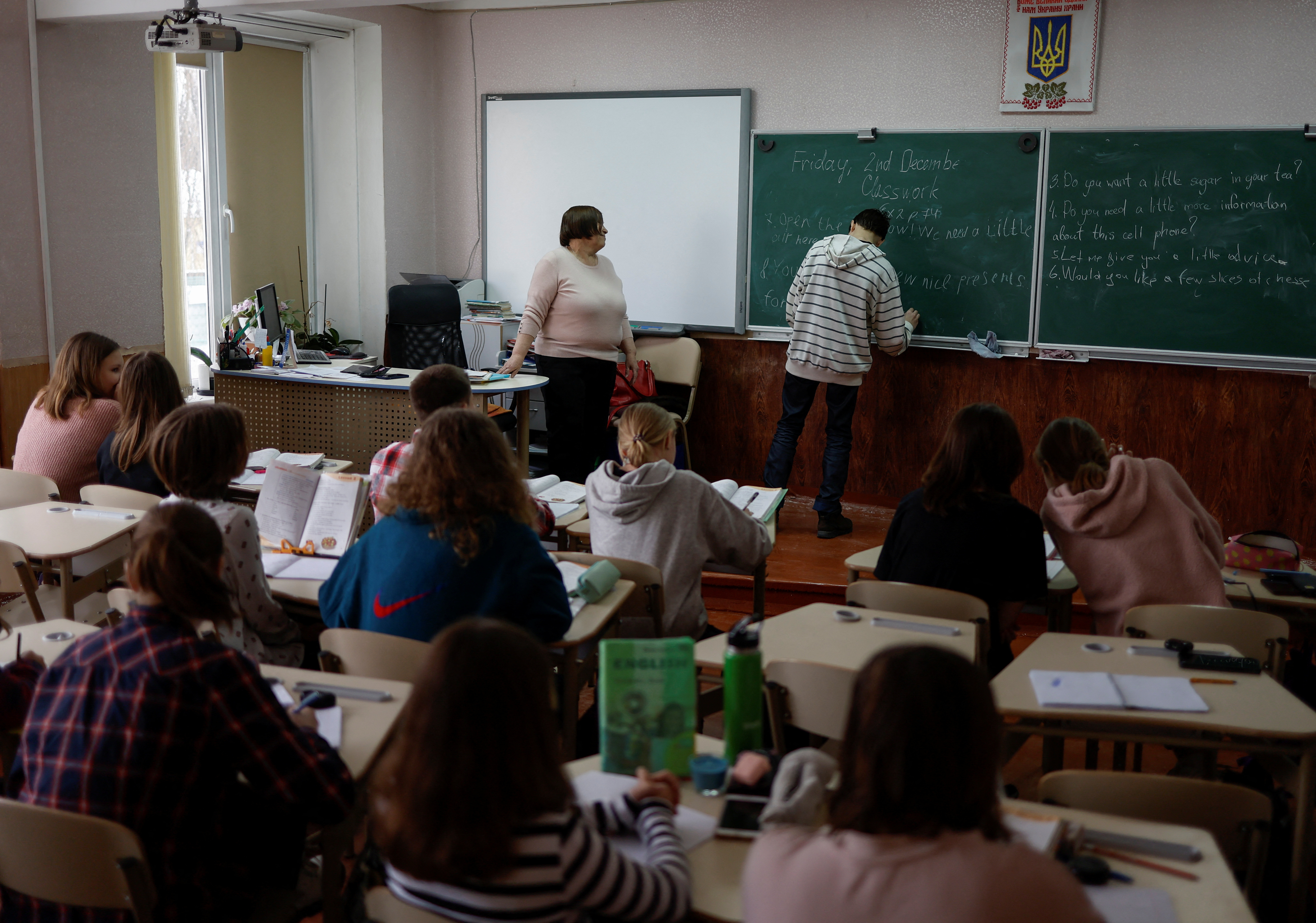 Students attend a lesson of English language in a classroom at a school in Kyiv