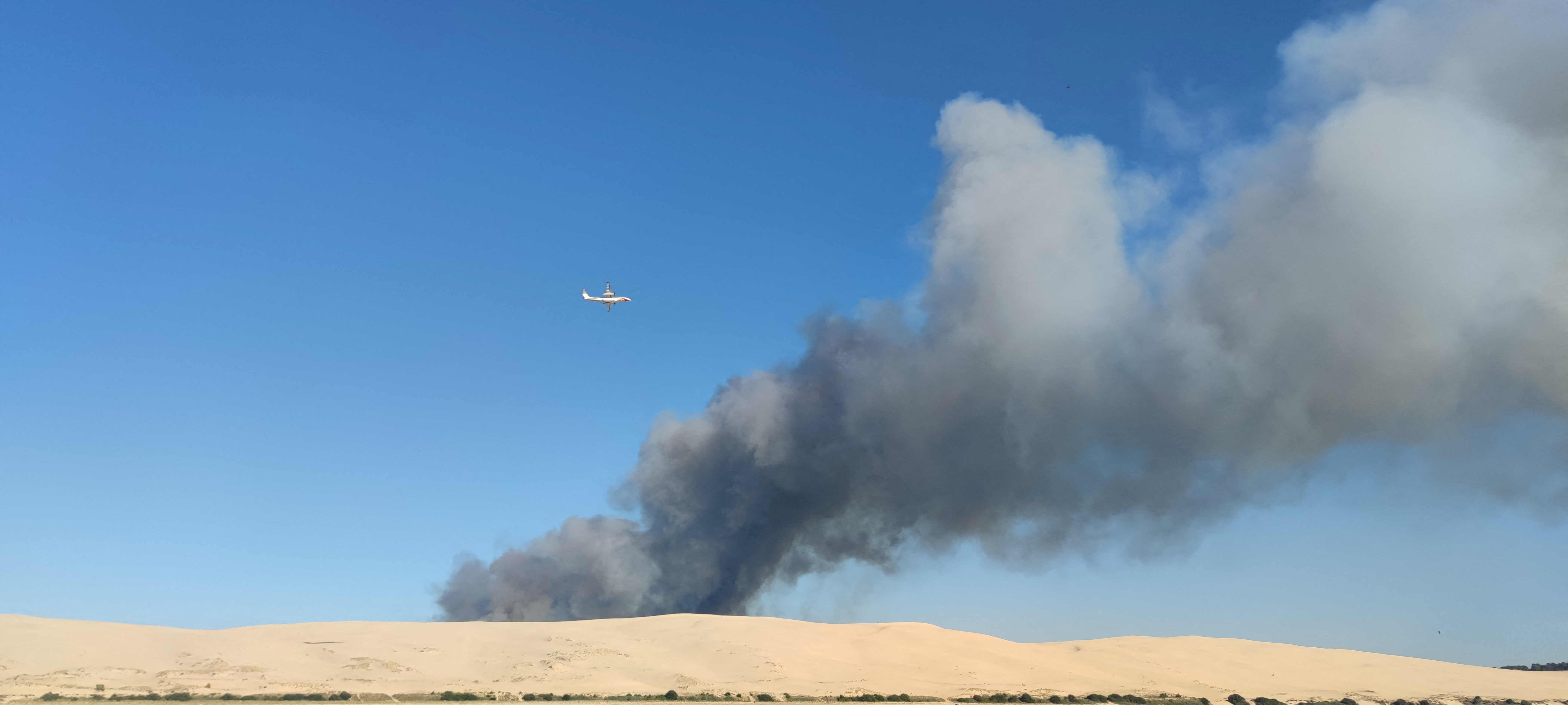A general view shows smoke rising from the Gironde forest fires as seen from Dune de Pilat