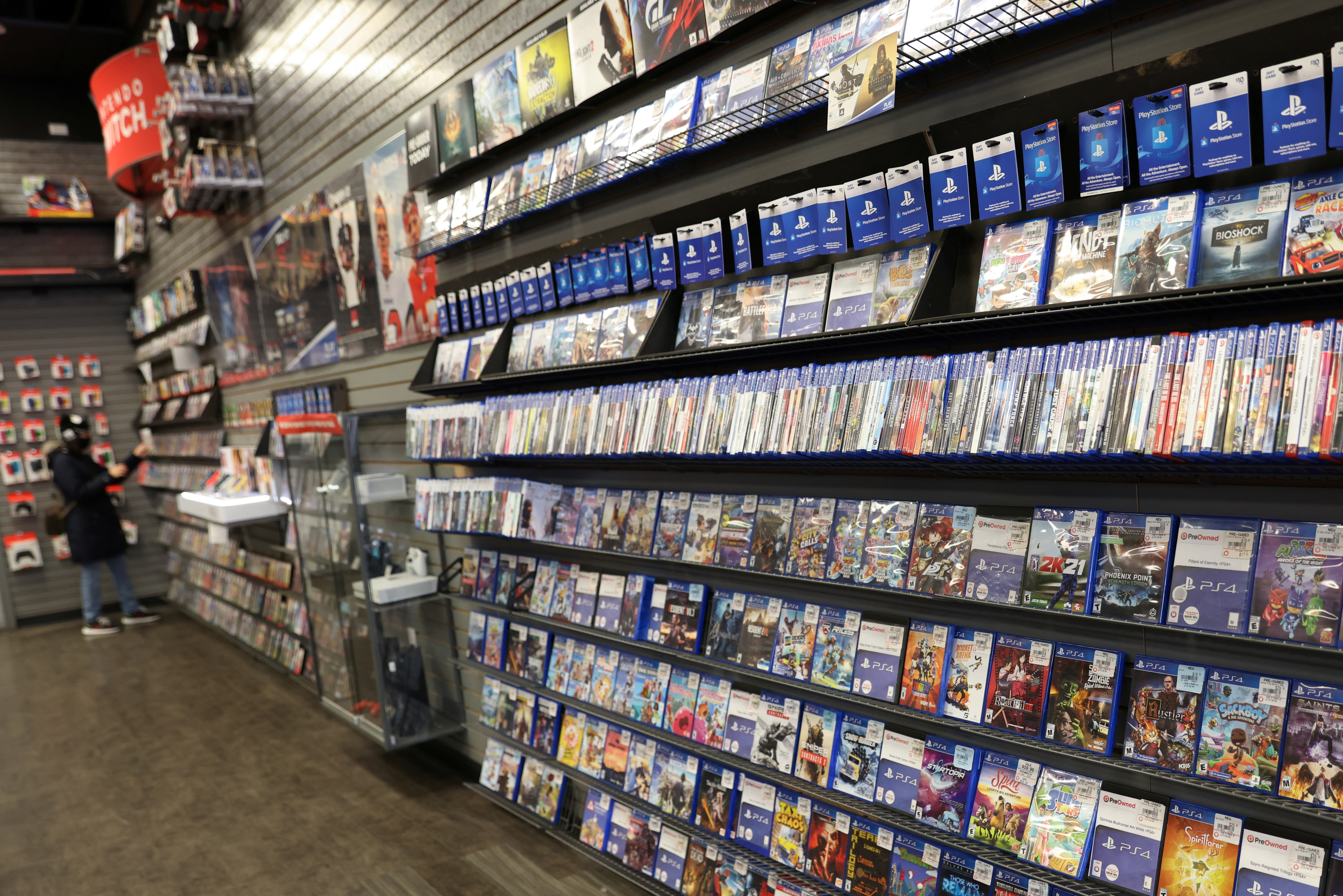 A person browses games in a GameStop in Manhattan, New York