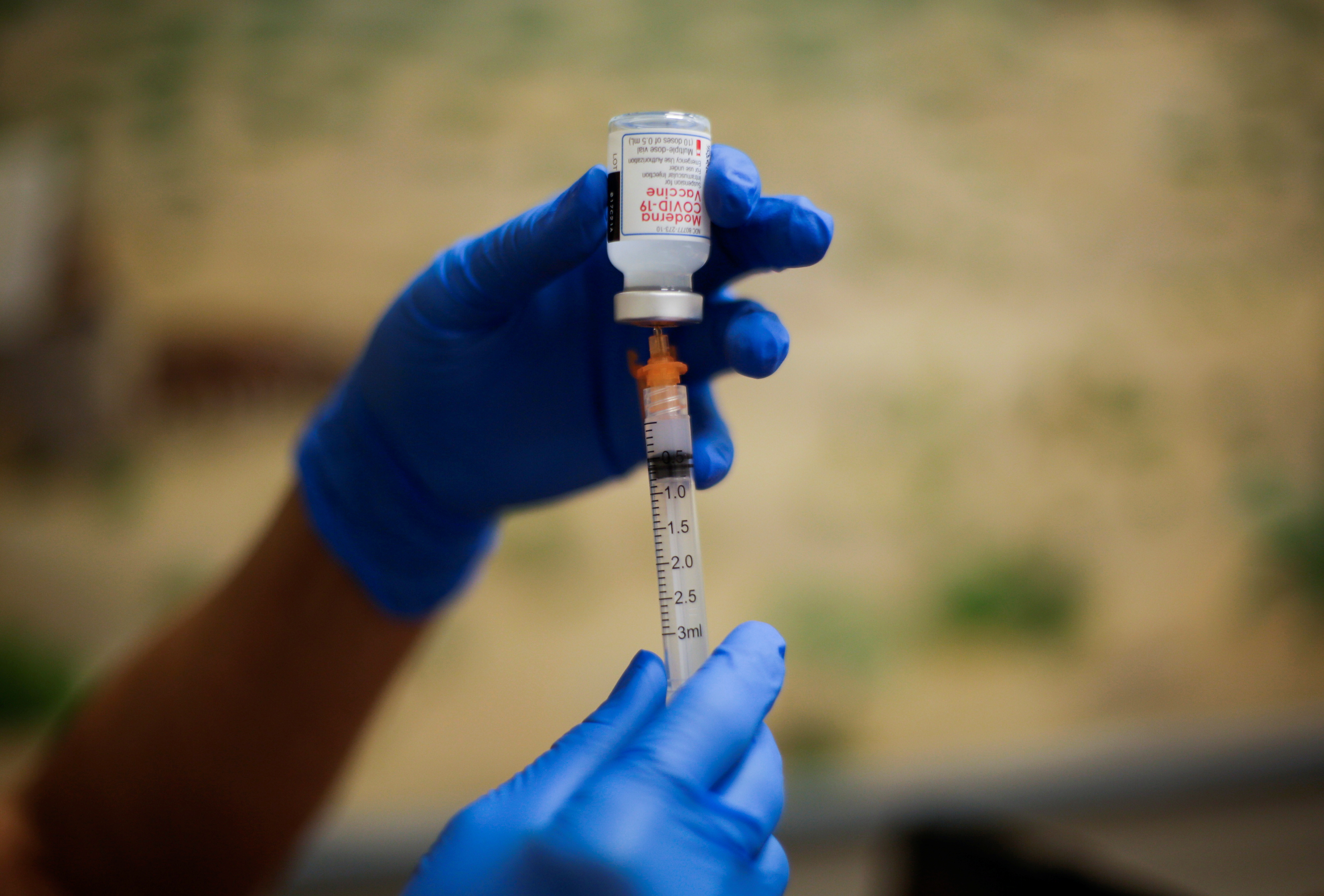 A healthcare worker prepares the Moderna vaccine against the coronavirus disease (COVID-19) at a vaccination centre, in El Paso