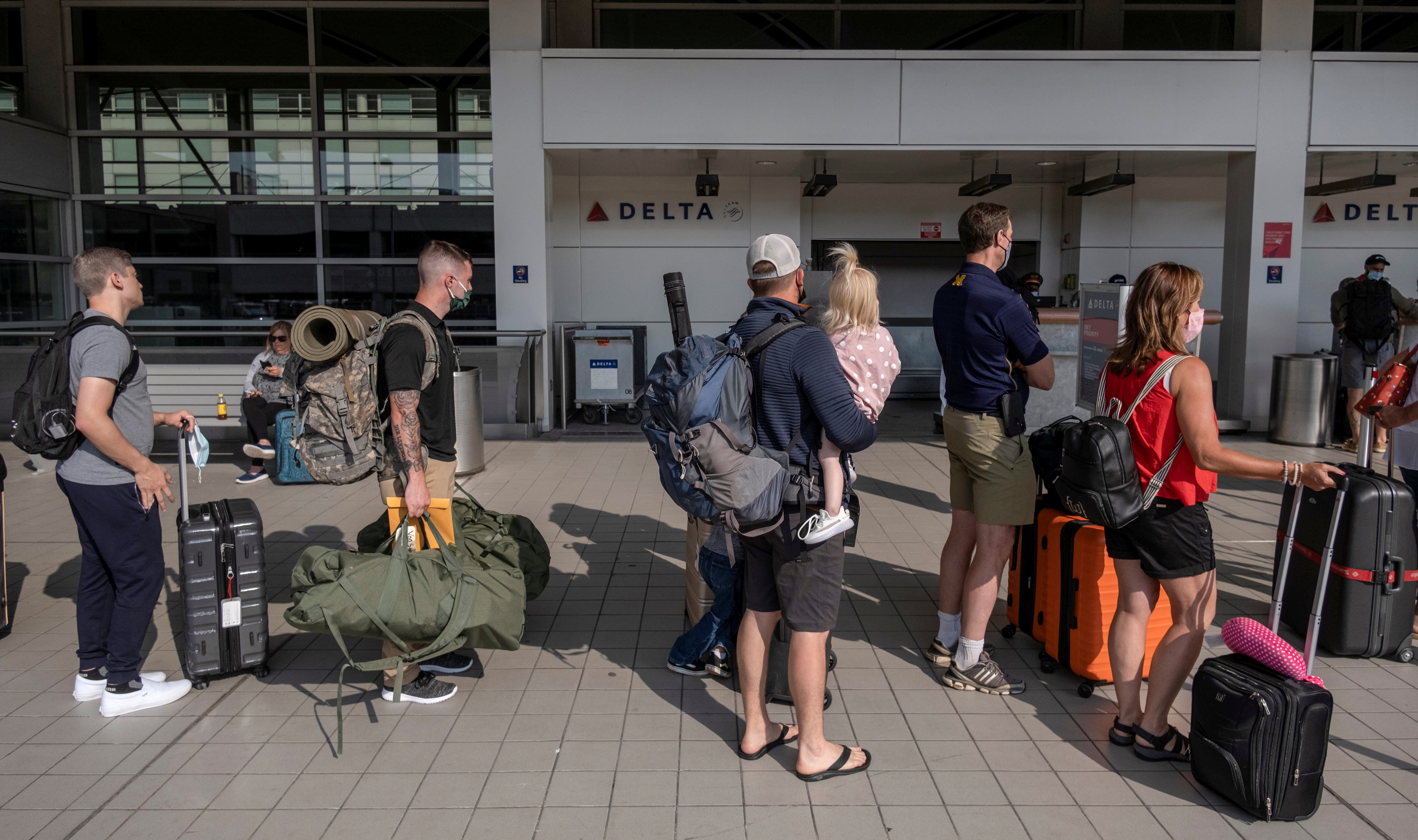 Travellers wait in line at Detroit Metropolitan Wayne County Airport in Detroit