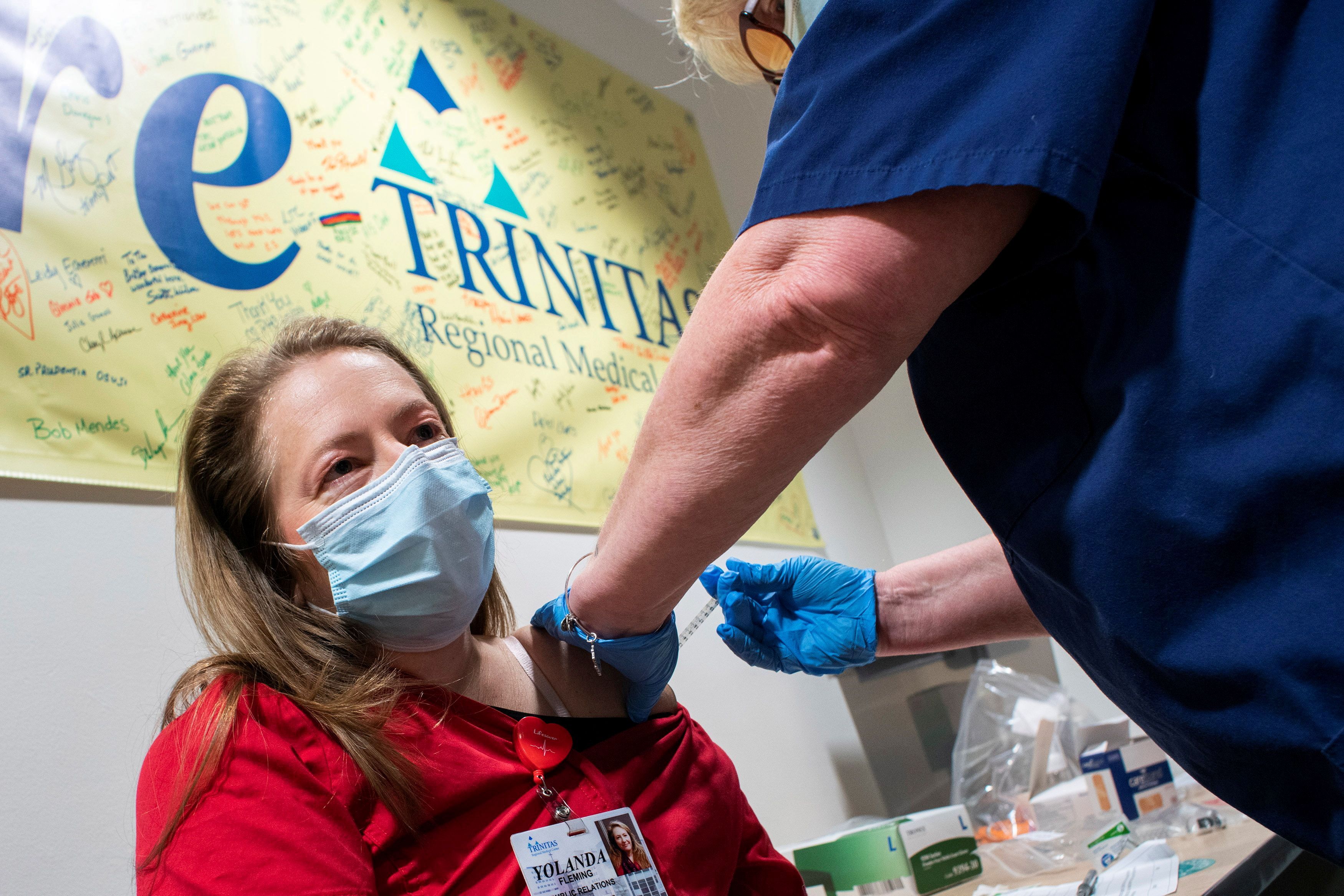 A healthcare worker gets vaccinated at the Trinitas Regional Medical Center in Elizabeth, New Jersey
