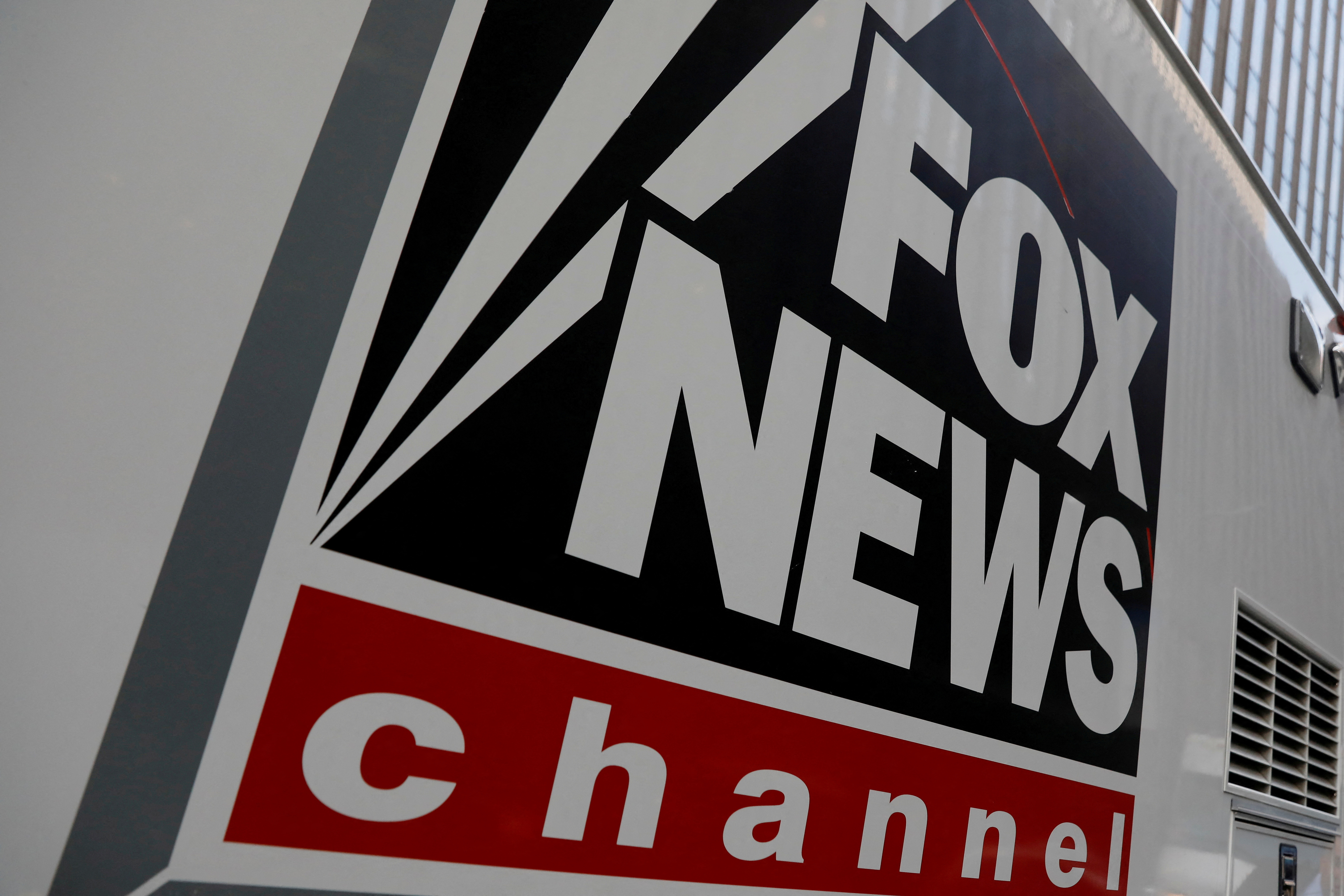 A Fox News channel sign is seen on a television vehicle outside the News Corporation building in New York City, in New York