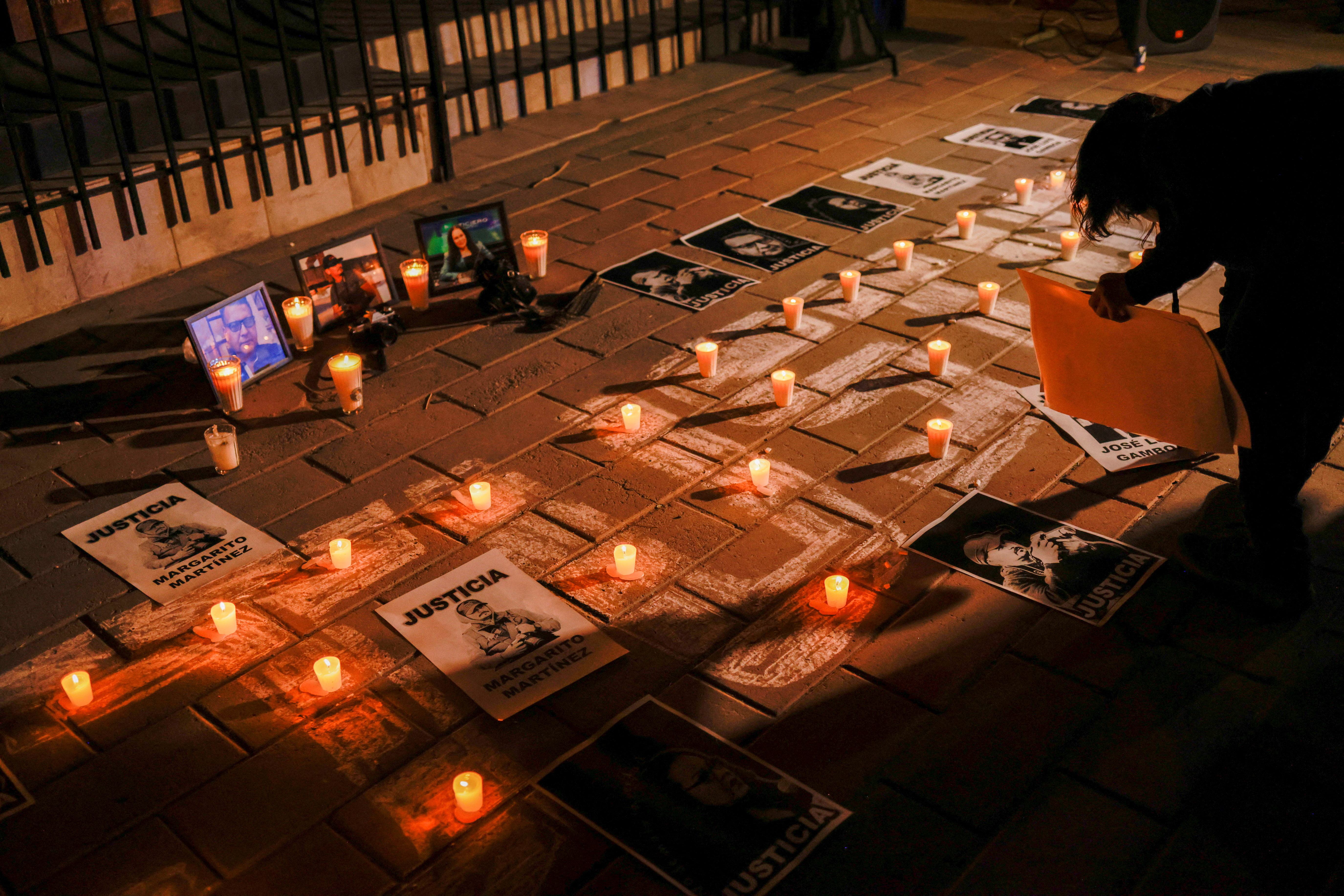 Signs portraying assassinated journalists and reading "Justice" are placed during a vigil held by journalists demanding justice and protection from the federal government following the killings of three colleagues on past days, in the Journalist's Square in Ciudad Juarez, Mexico, January 25, 2022. REUTERS/Jose Luis Gonzalez