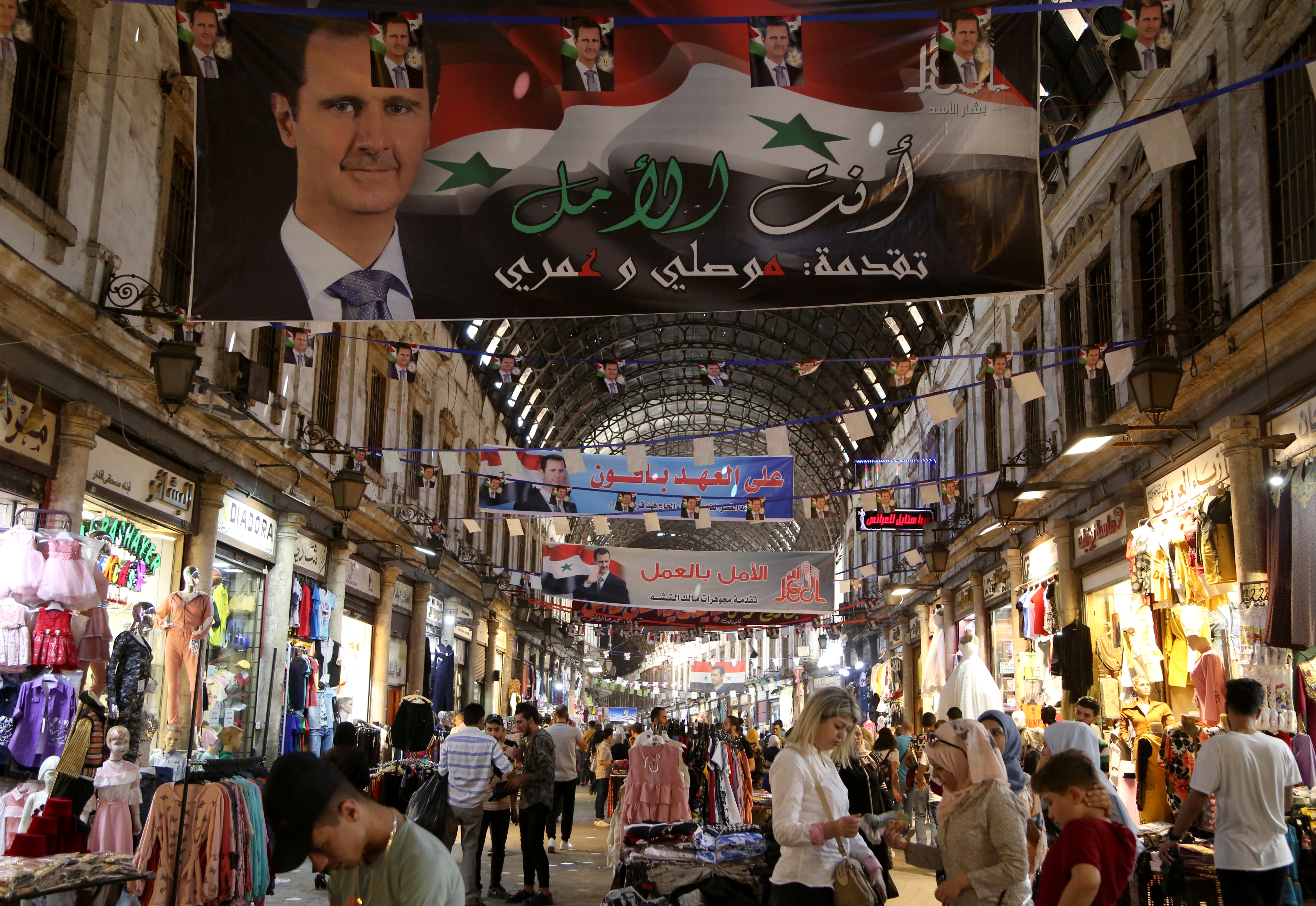 People shop at Souk al-Hamidieh in Damascus