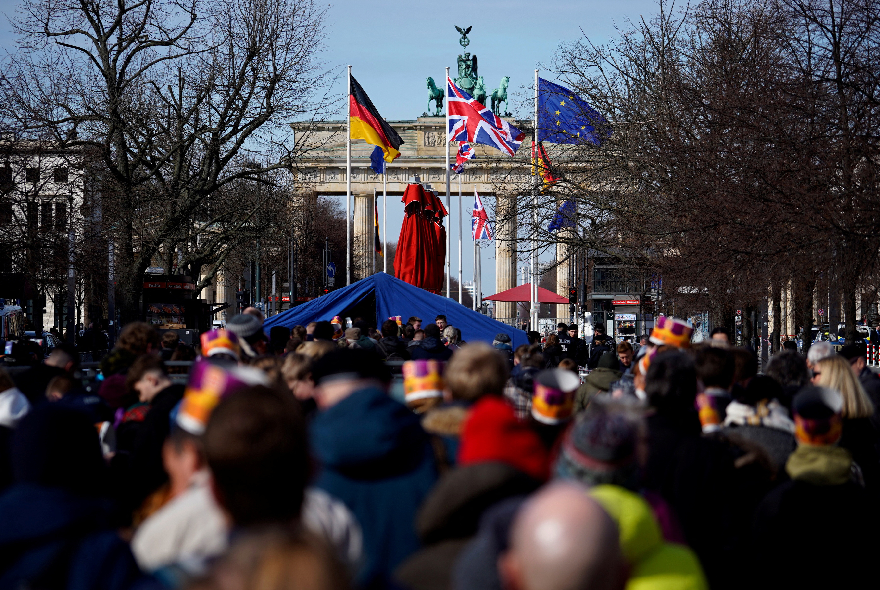People line up in front of Brandenburg Gate to attend the welcome ceremony for Britain's King Charles in Berlin