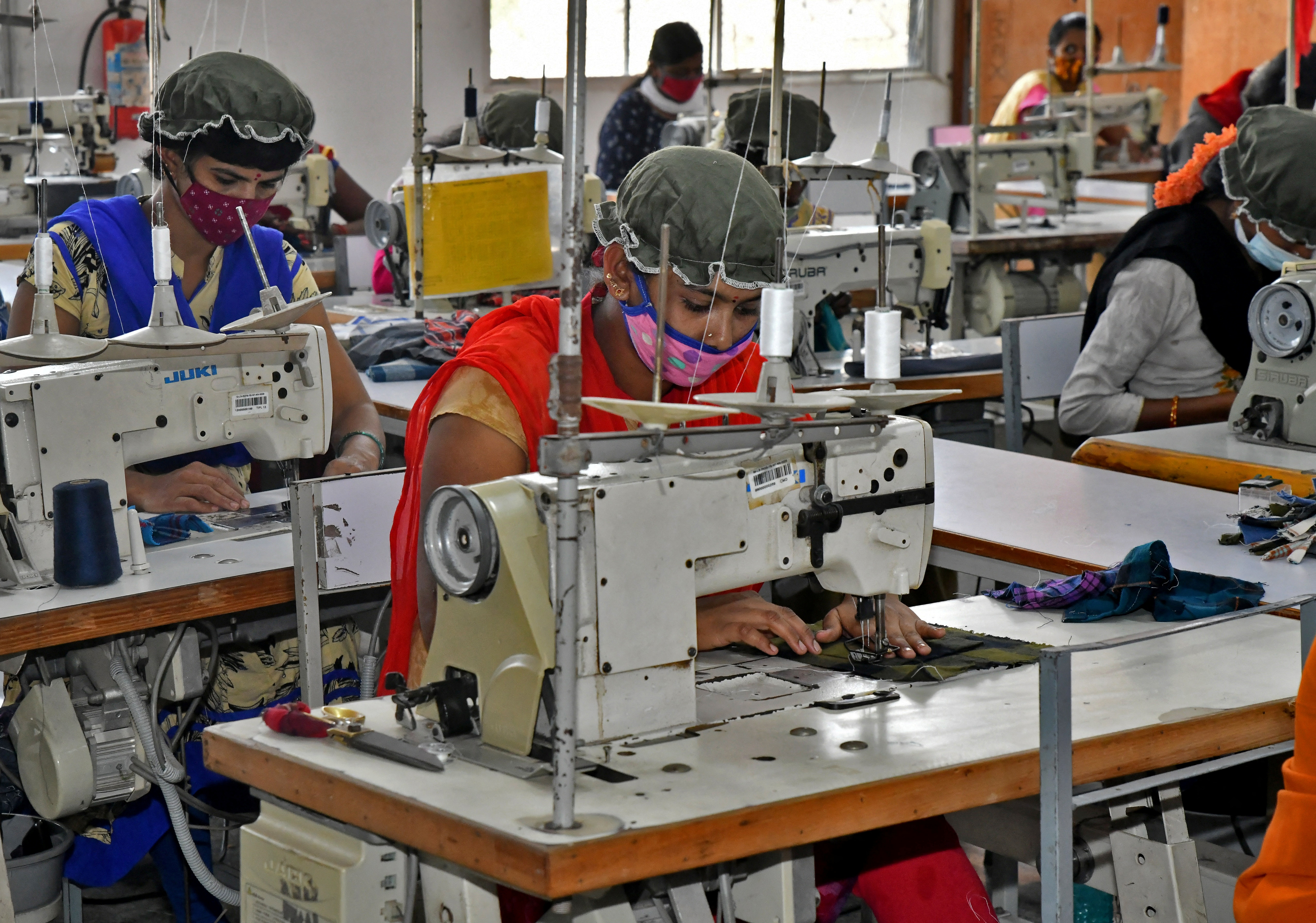 Newly recruited garment workers practice stitching at a textile factory of Texport Industries in Hindupur