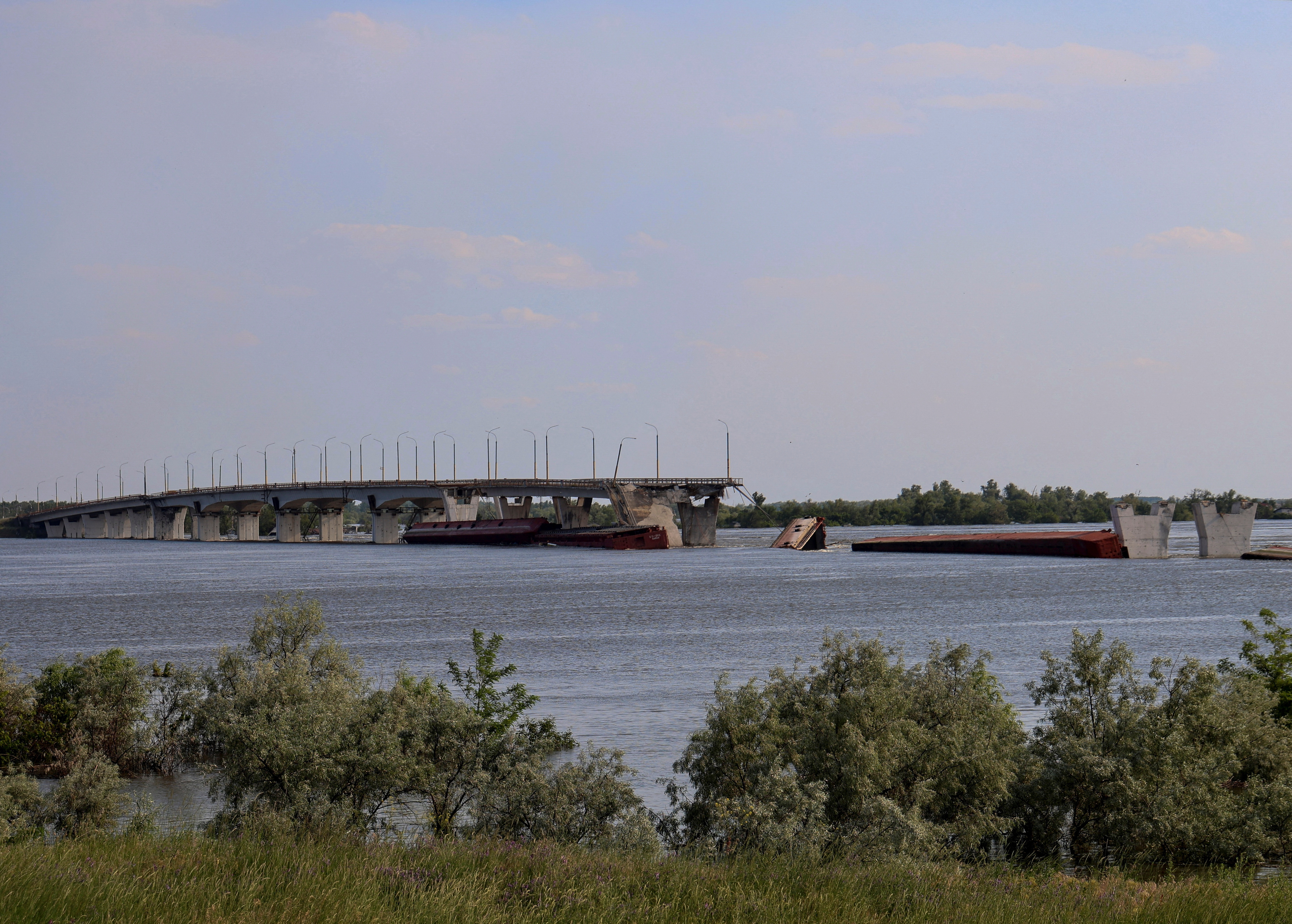 Destroyed Antonivskyi bridge is seen over the flooded Dnipro river after the Nova Kakhovka dam breached, near Kherson