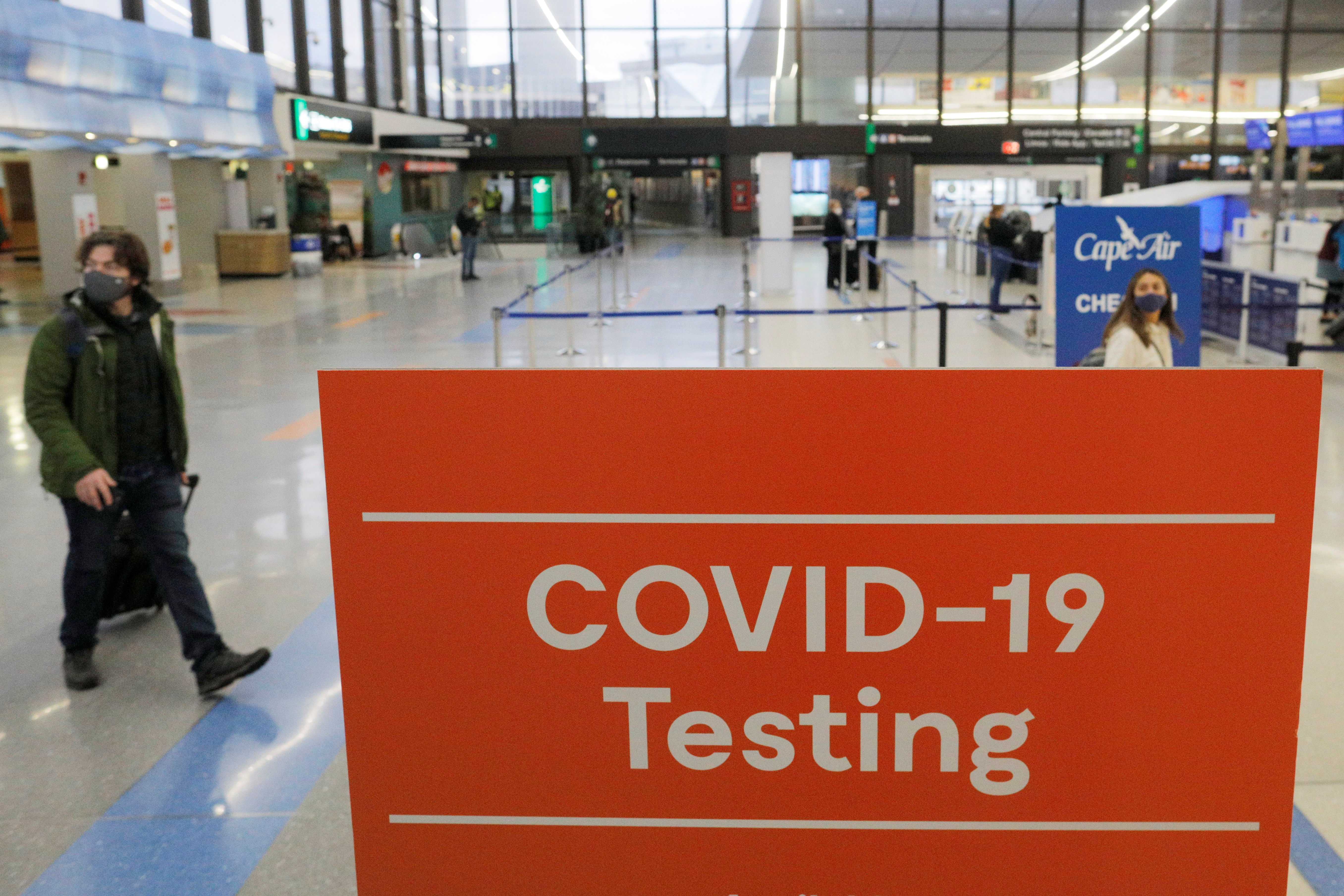 A sign advertises coronavirus disease (COVID-19) testing ahead of the Thanksgiving holiday at Logan International Airport in Boston, Massachusetts, U.S., November 22, 2021. REUTERS/Brian Snyder