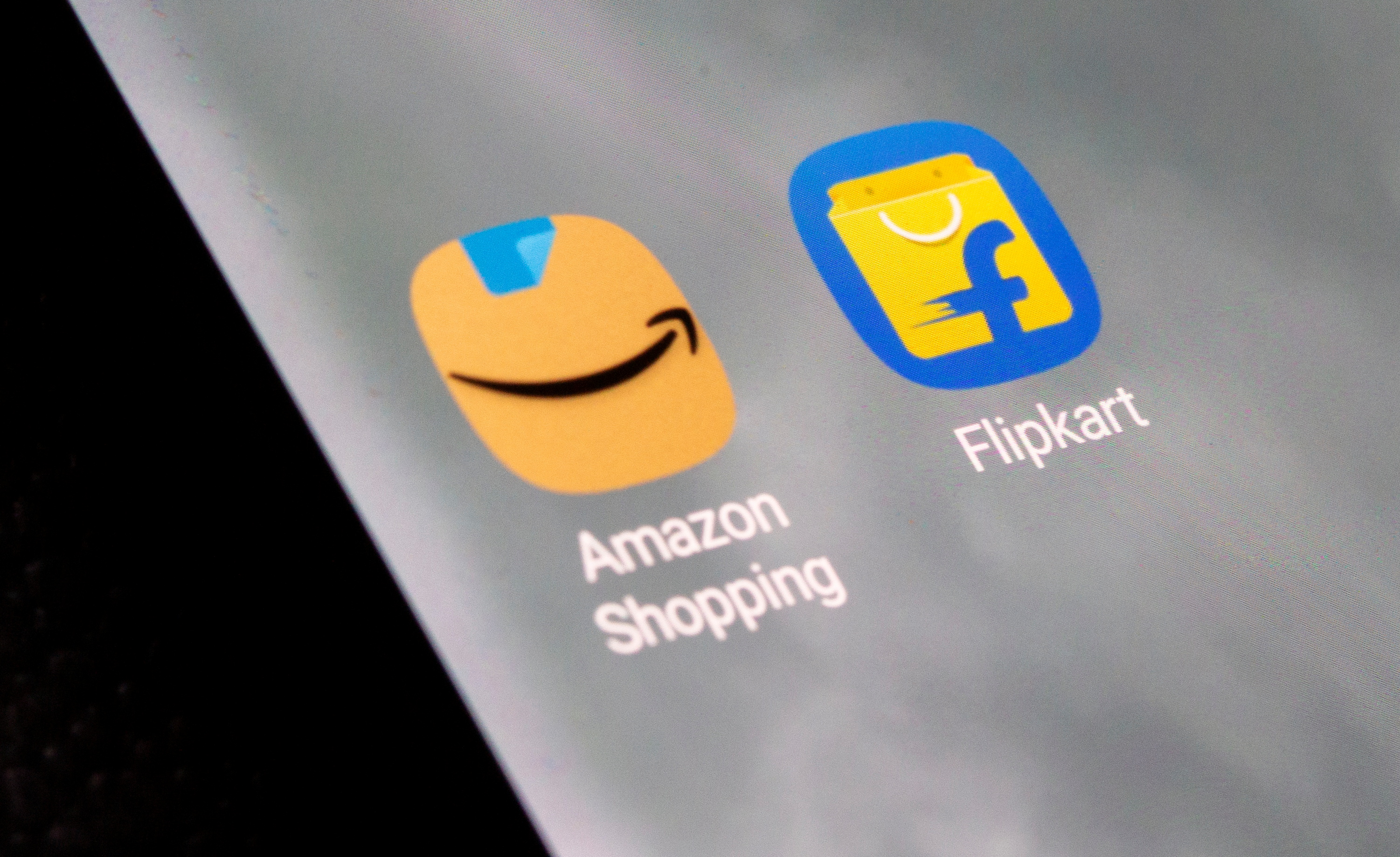 Amazon Shopping and Flipkart apps are seen on the smartphone in this illustration taken
