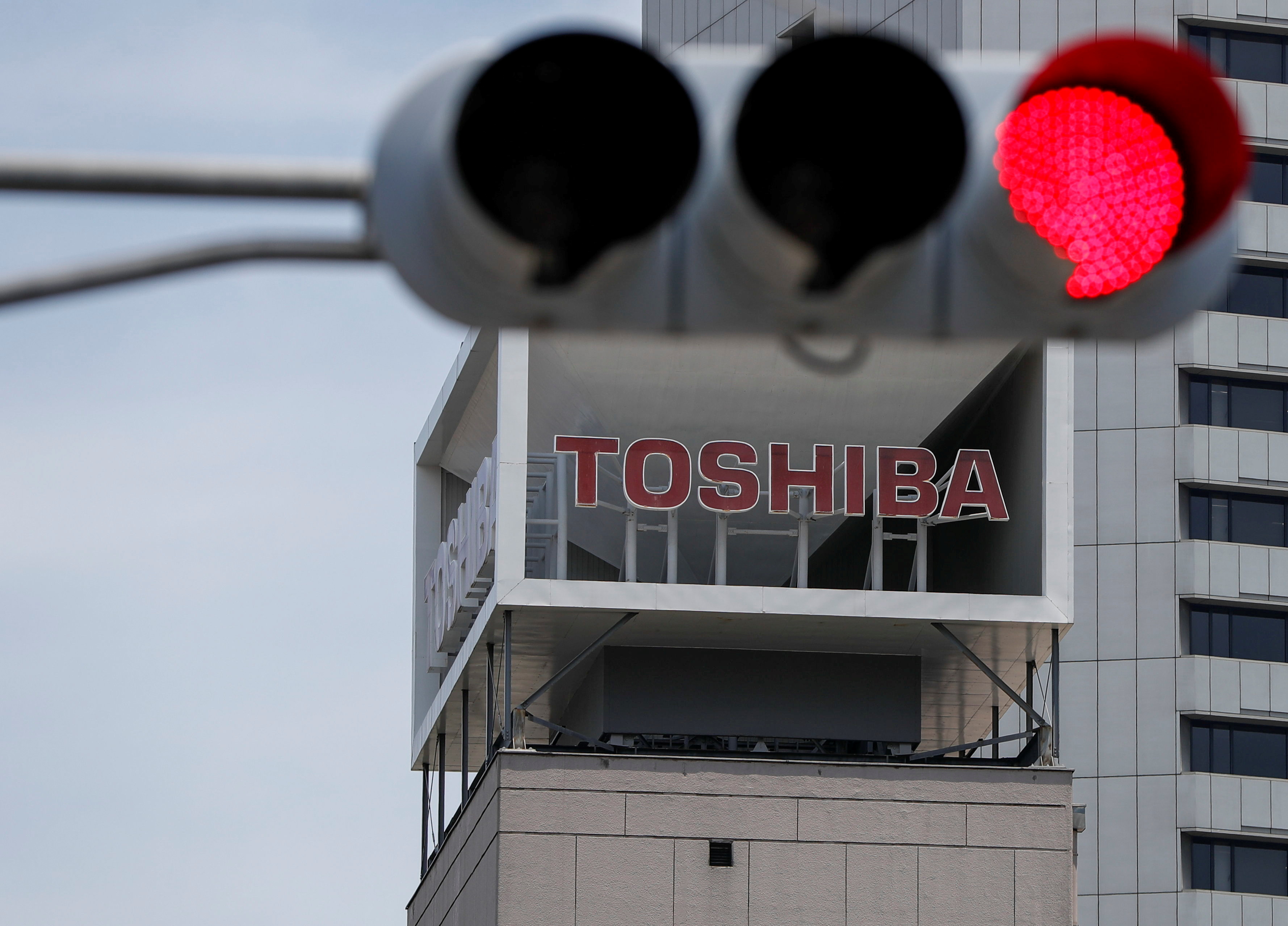 The logo of Toshiba Corp. is seen next to a traffic signal atop of a building in Tokyo