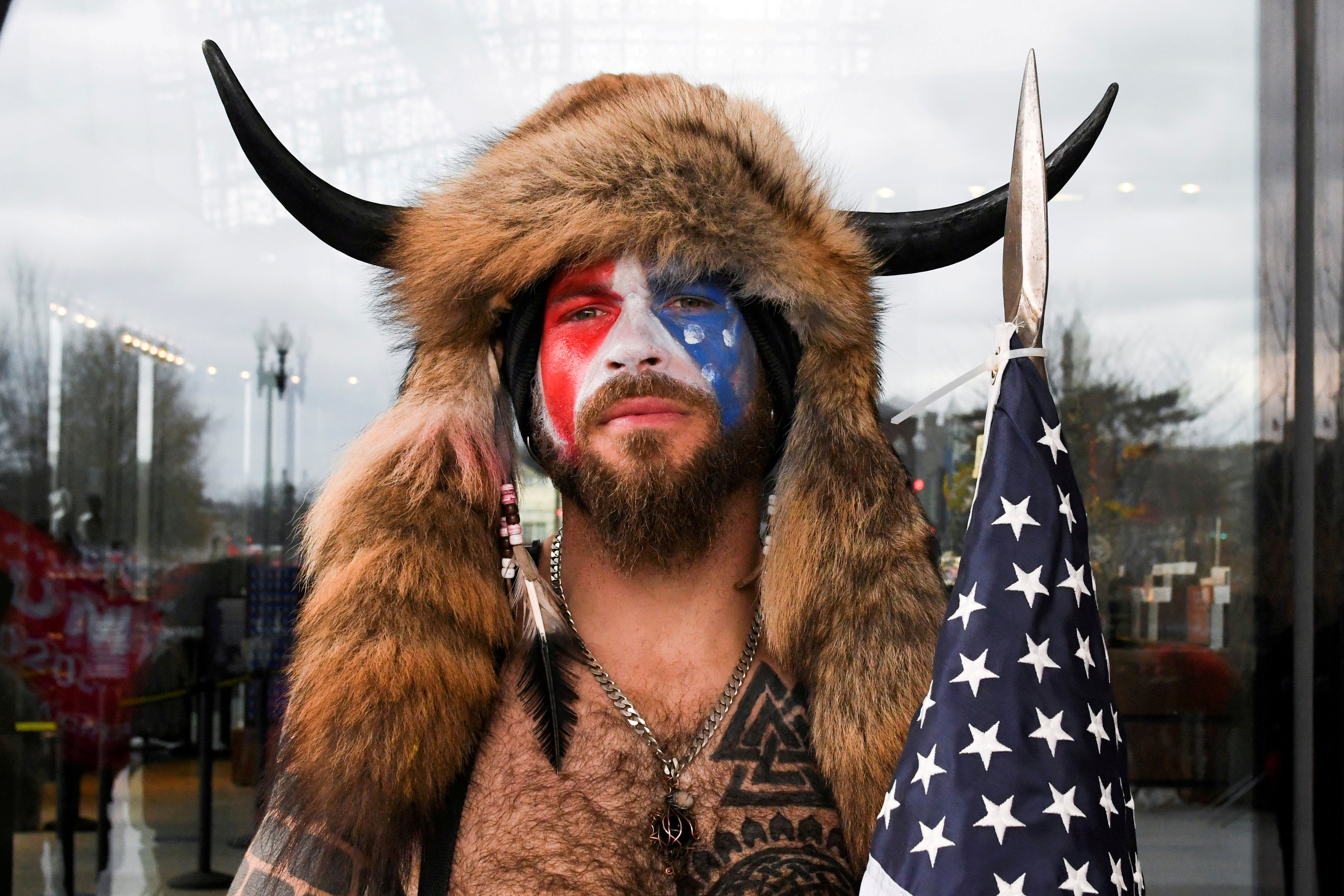 Man poses with his face painted in the colors of the U.S. flag in Washington