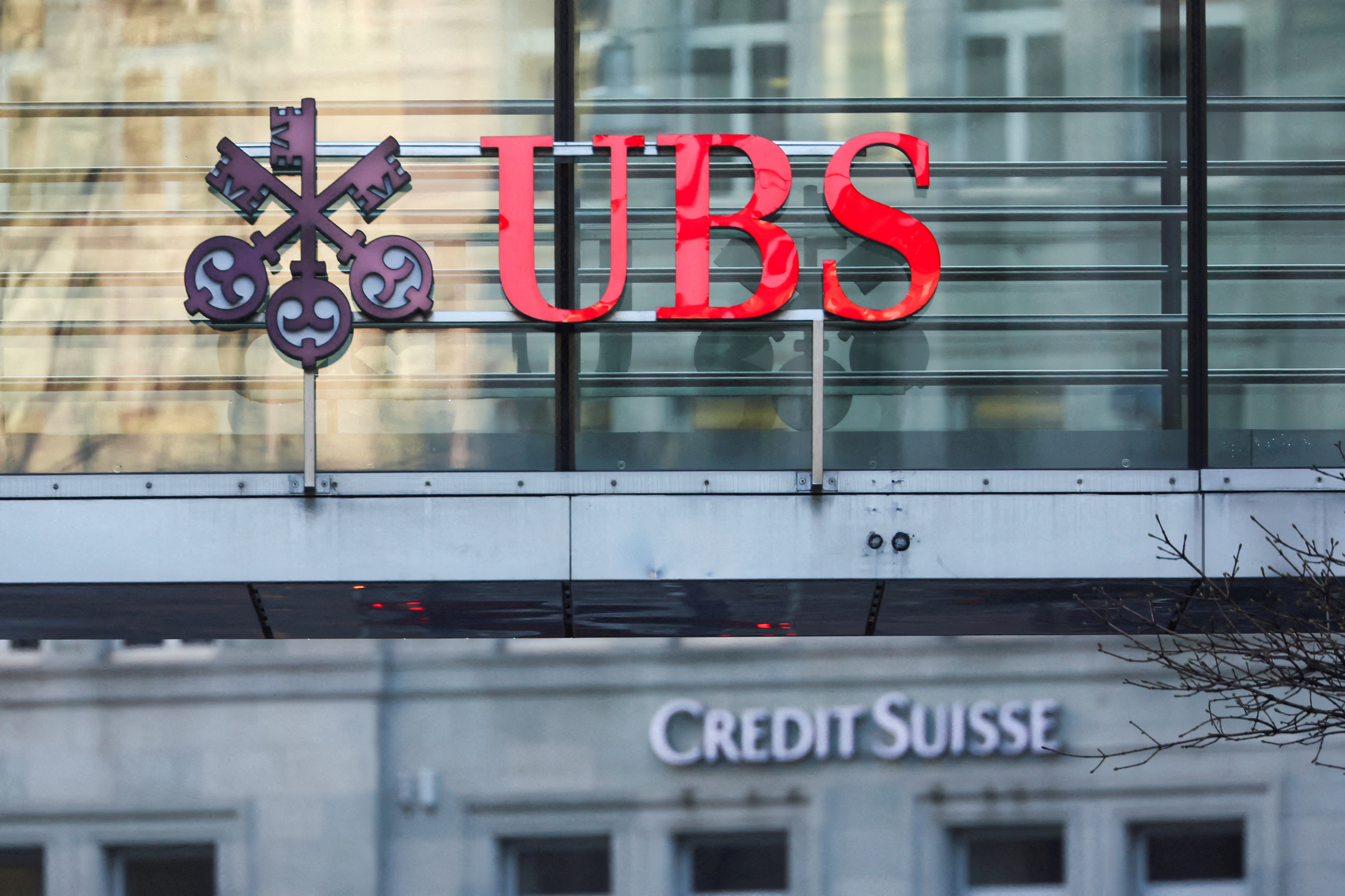 FILE PHOTO: Logos of Swiss banks UBS and Credit Suisse are seen in Zurich, Switzerland