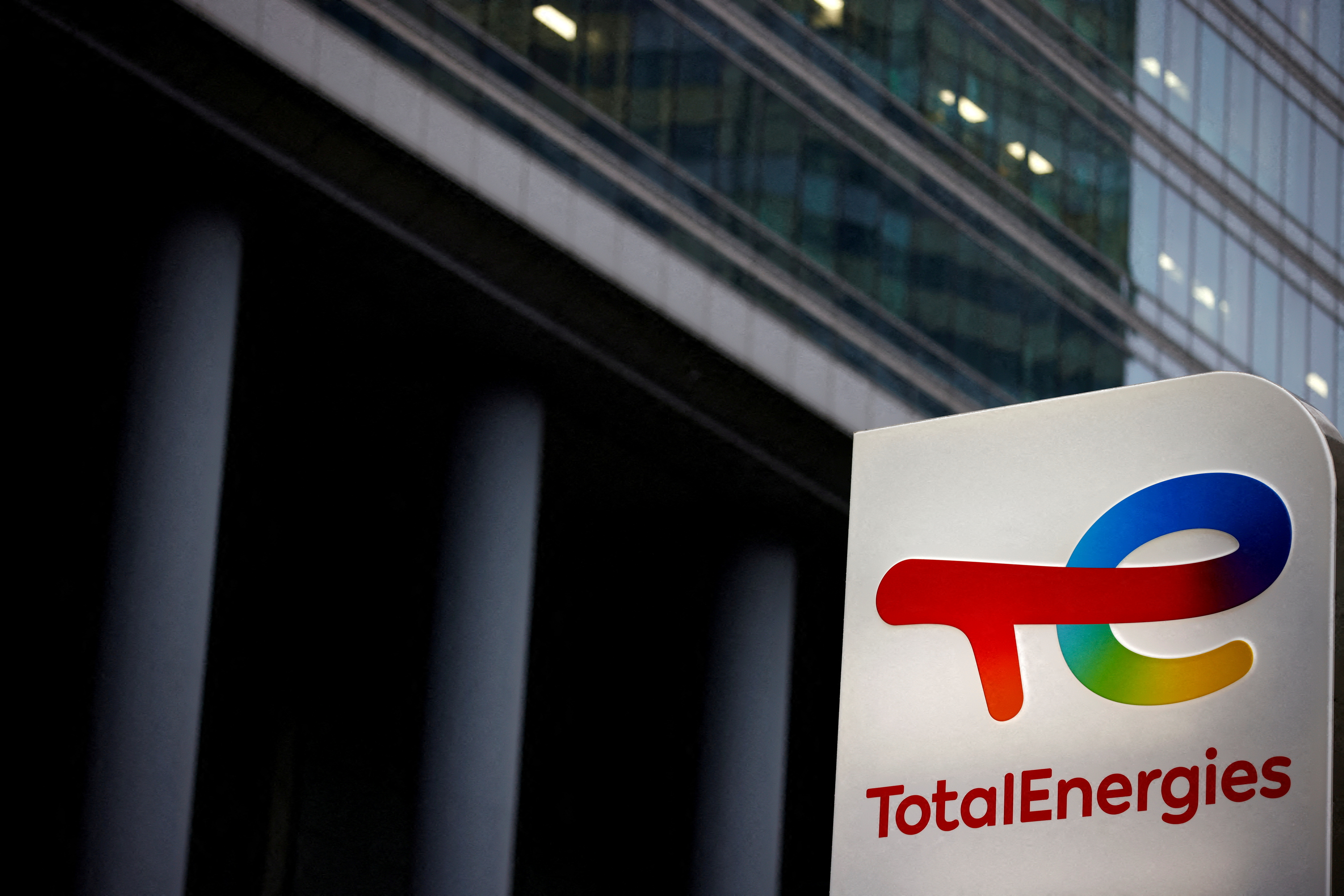 The logo of French oil and gas company TotalEnergies is pictured at an electric car charging station in Courbevoie