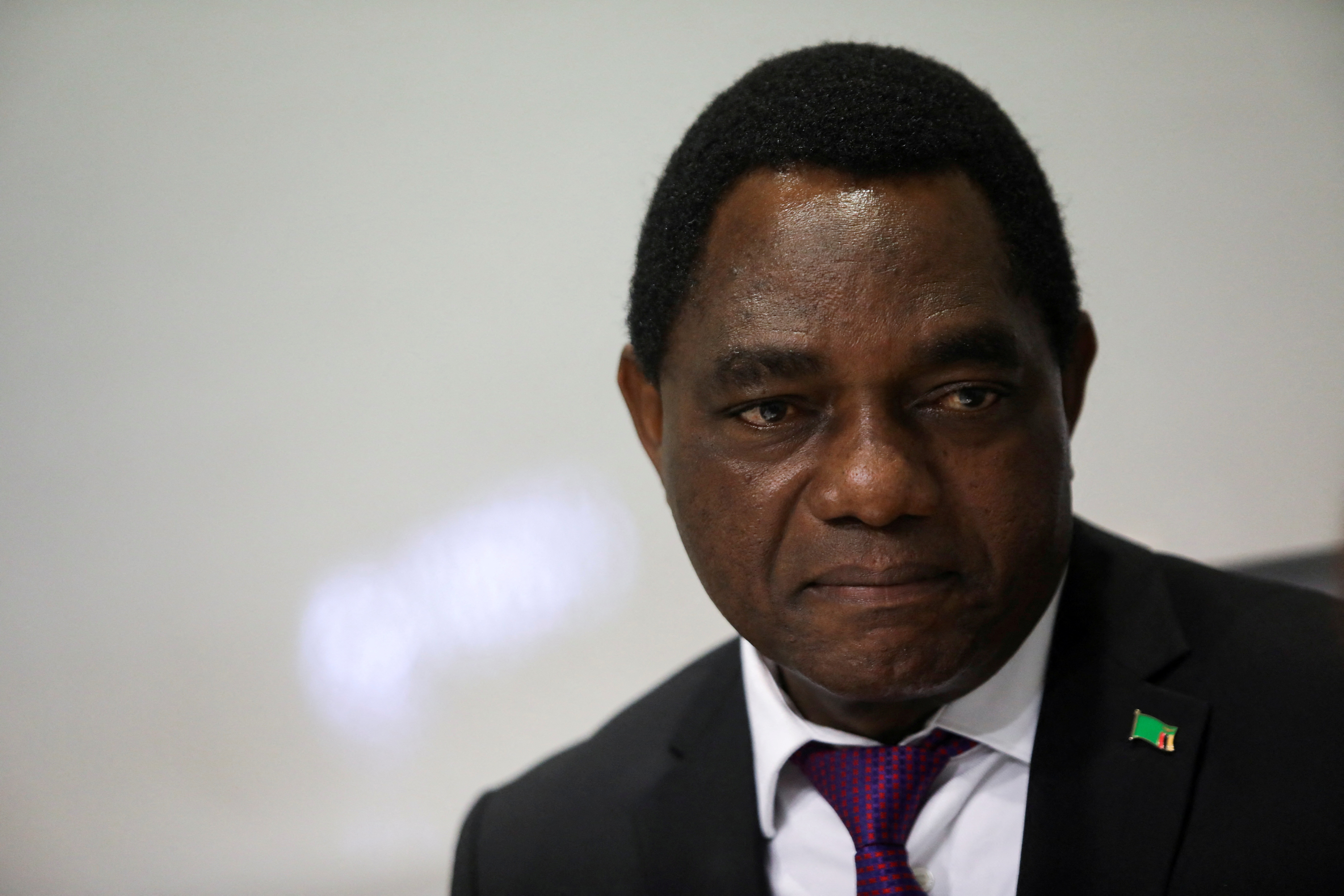Zambian President Hakainde Hichilema looks on during interview with Reuters.