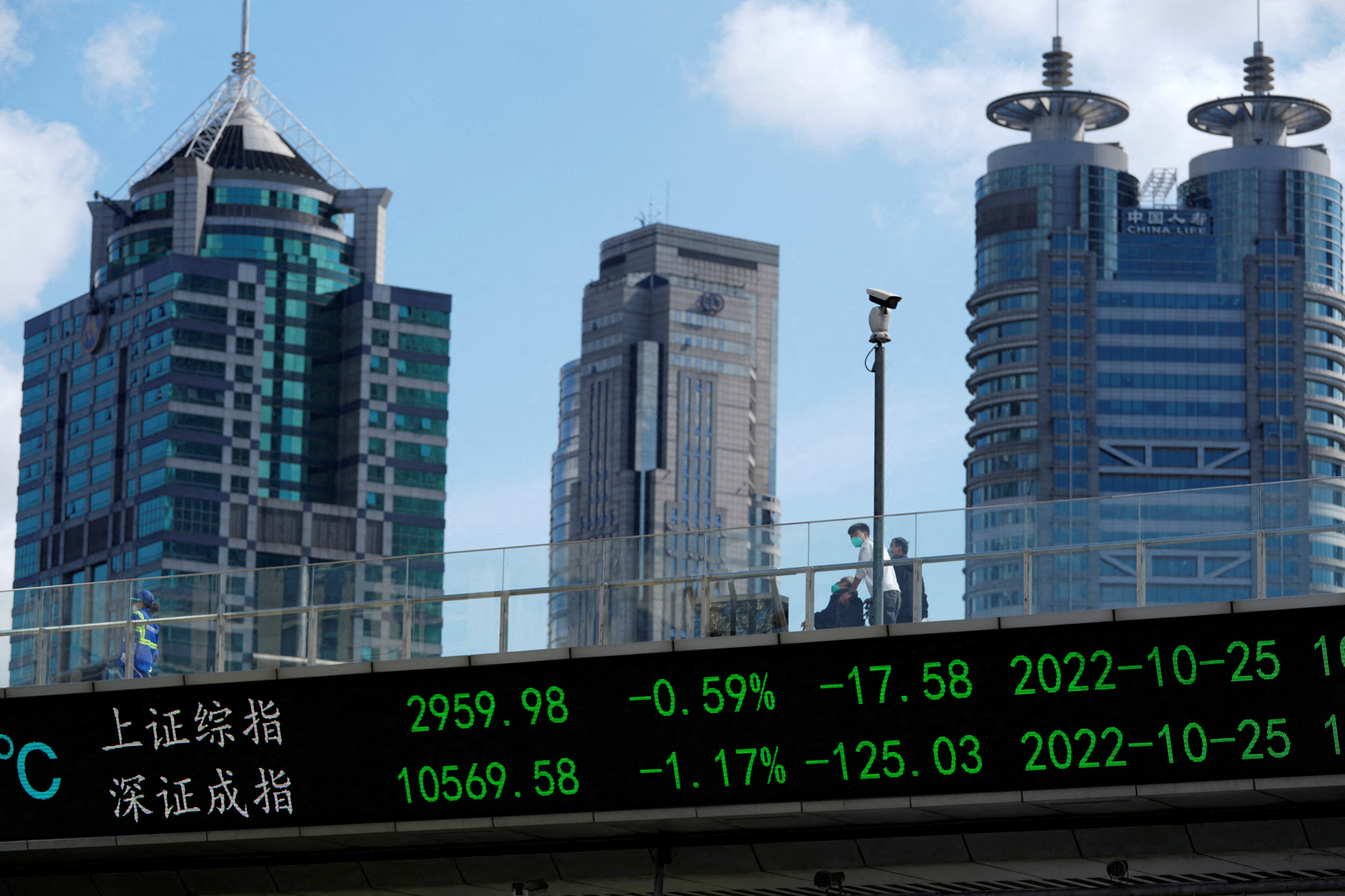 An electronic board shows Shanghai and Shenzhen stock indexes in Shanghai