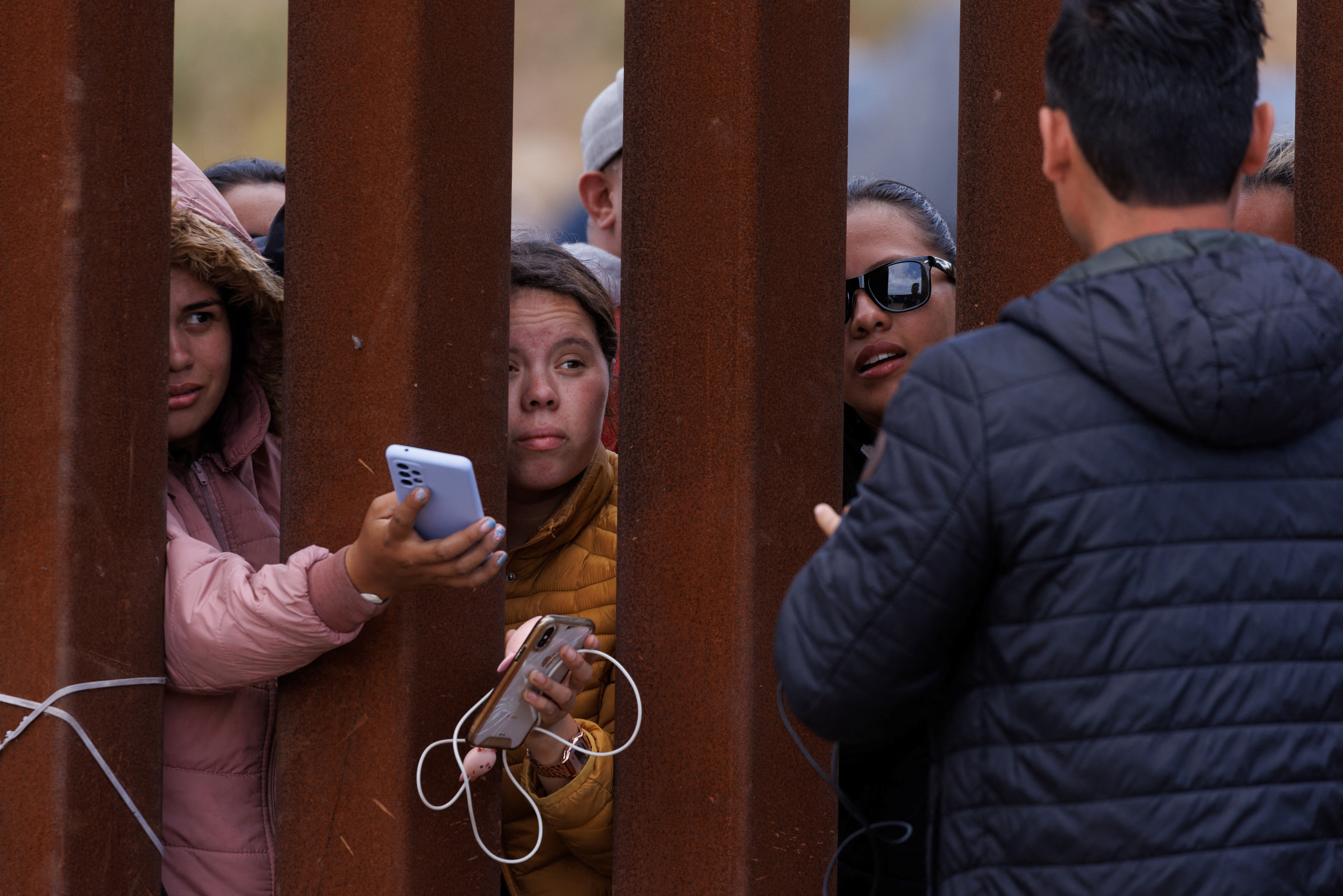 Migrants gather along the U.S. Mexico border near San Diego before the lifting of Tile 42