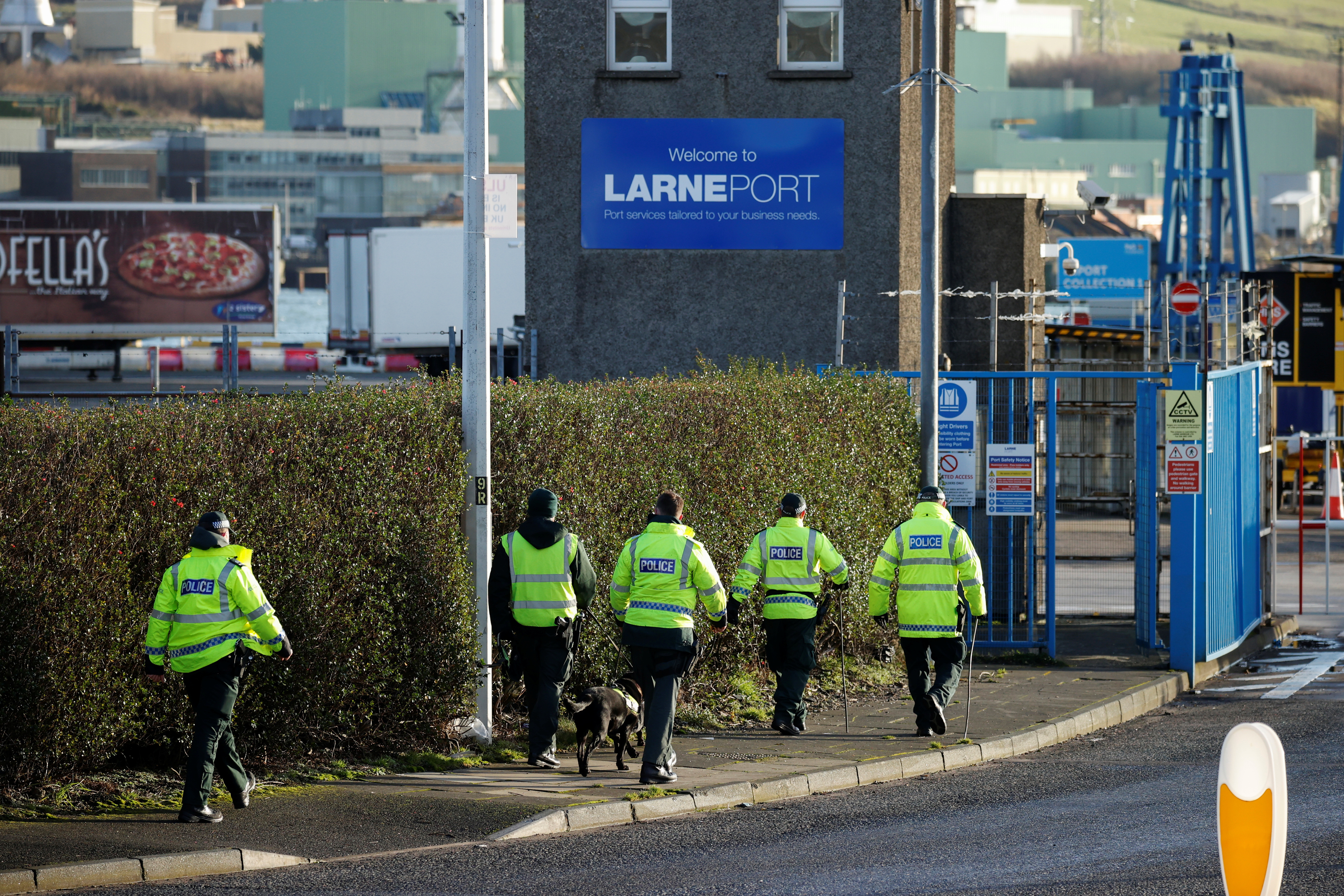 Police officers carry out a security sweep near the Port of Larne
