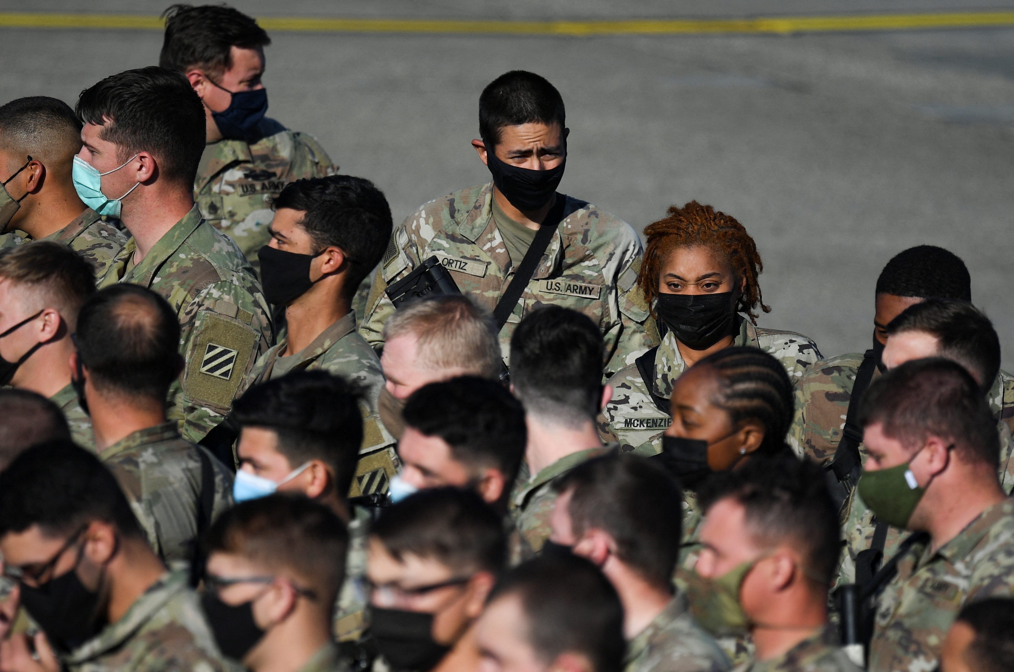 U.S. troops in transfer to military base in Grafenwoehr to strengten NATO efforts in Eastern Europe as Russian invasion on Ukraine continues, stand in formation at the Albrecht Duerer Airport in Nuremberg, Germany March 1, 2022. REUTERS/Andreas Gebert