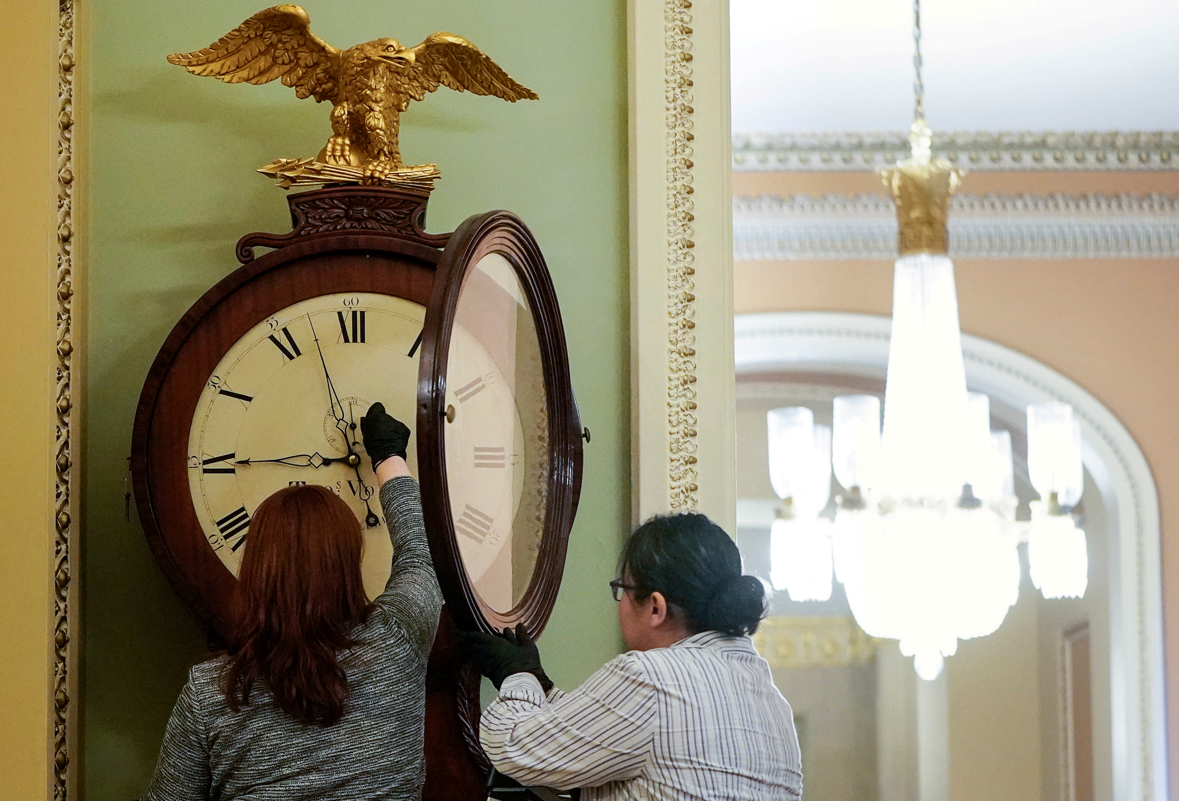 Architect of the Capitol workers wind Ohio Clock in Washington