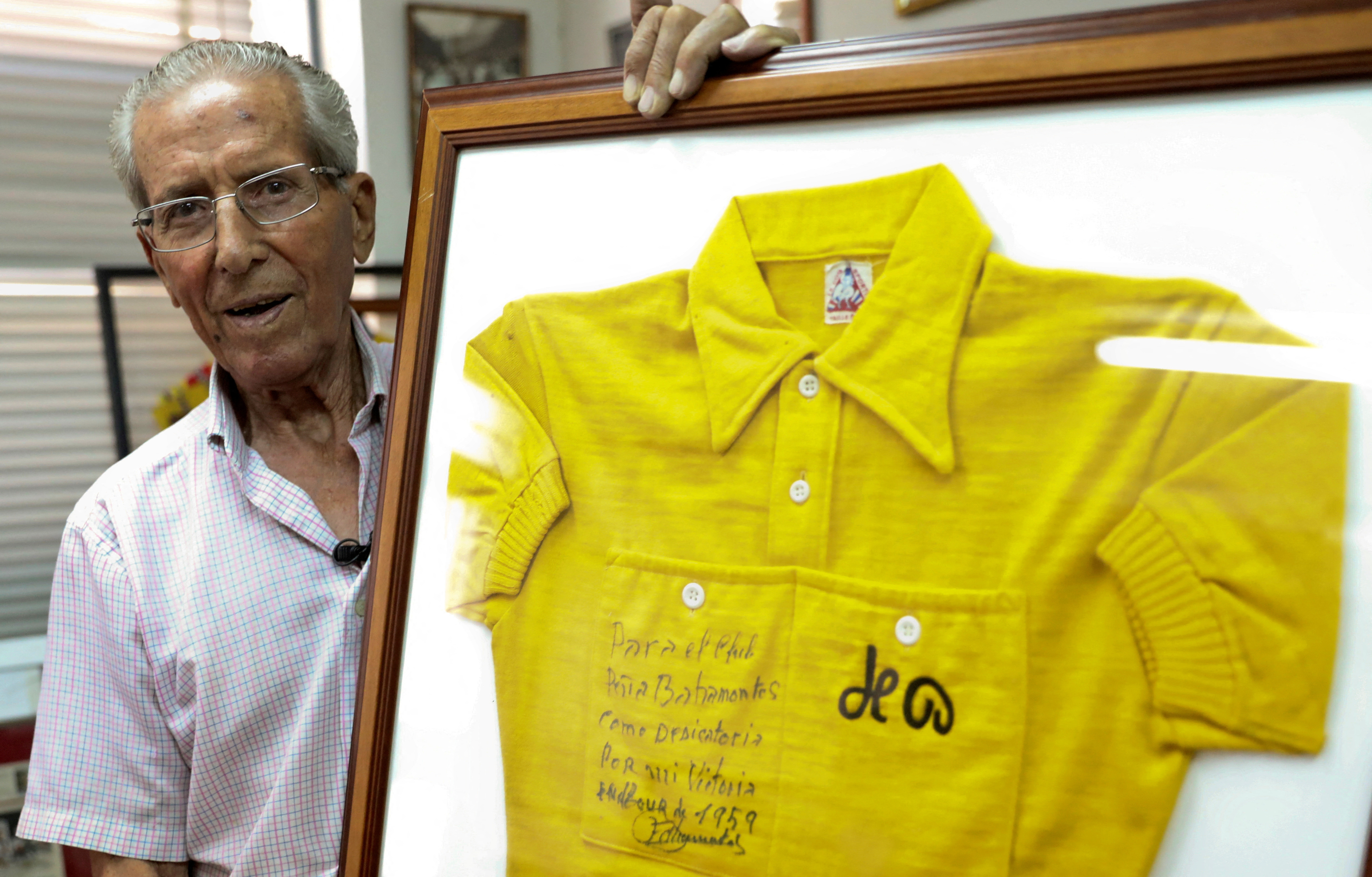 Bahamontes, 91, poses with his original yellow jersey at his fans club headquarters in Toledo