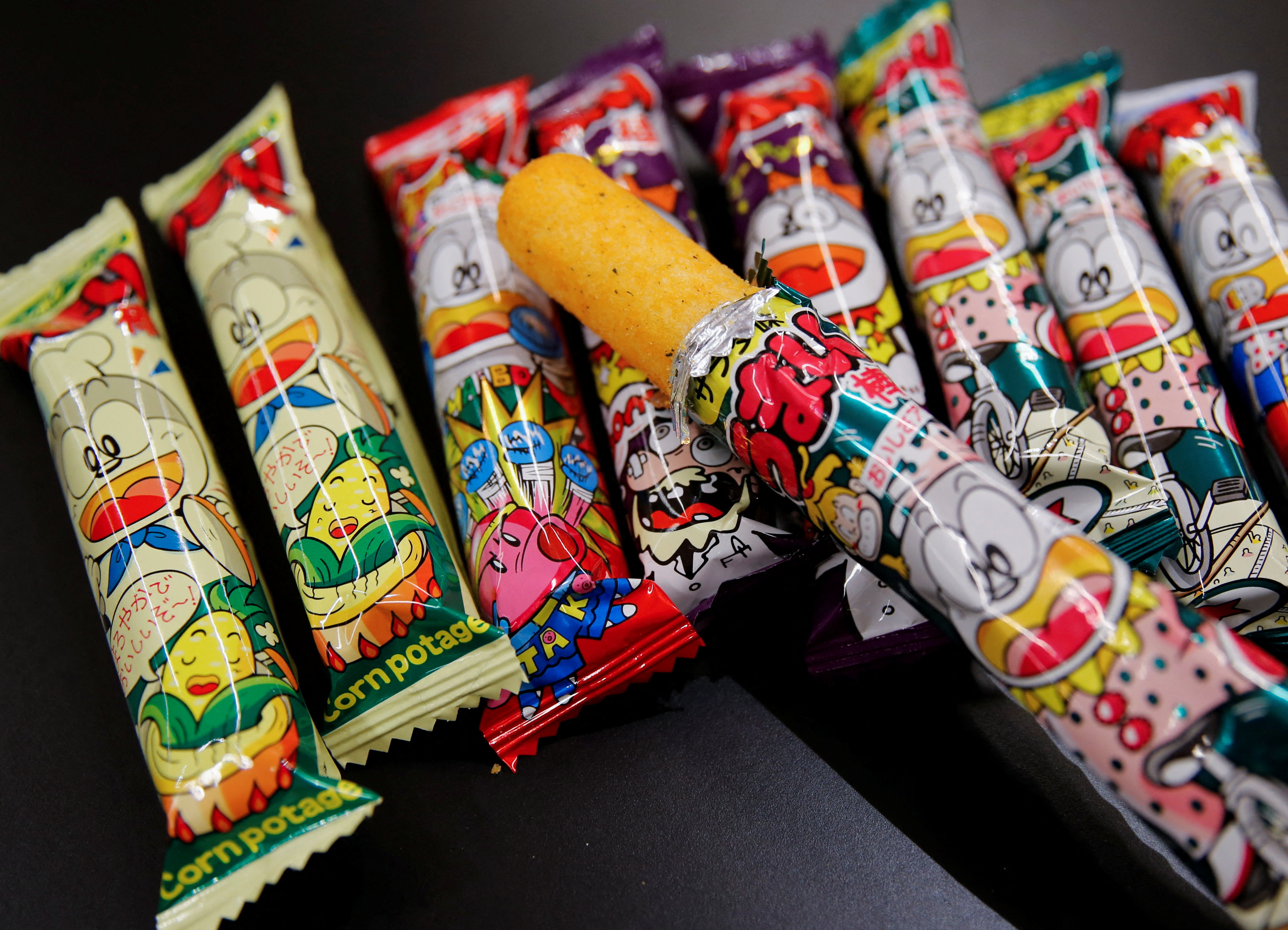 Several flavours of 'Umaibo', a popular Japanese corn snack, are displayed at a confectionery wholesaler's in Tokyo