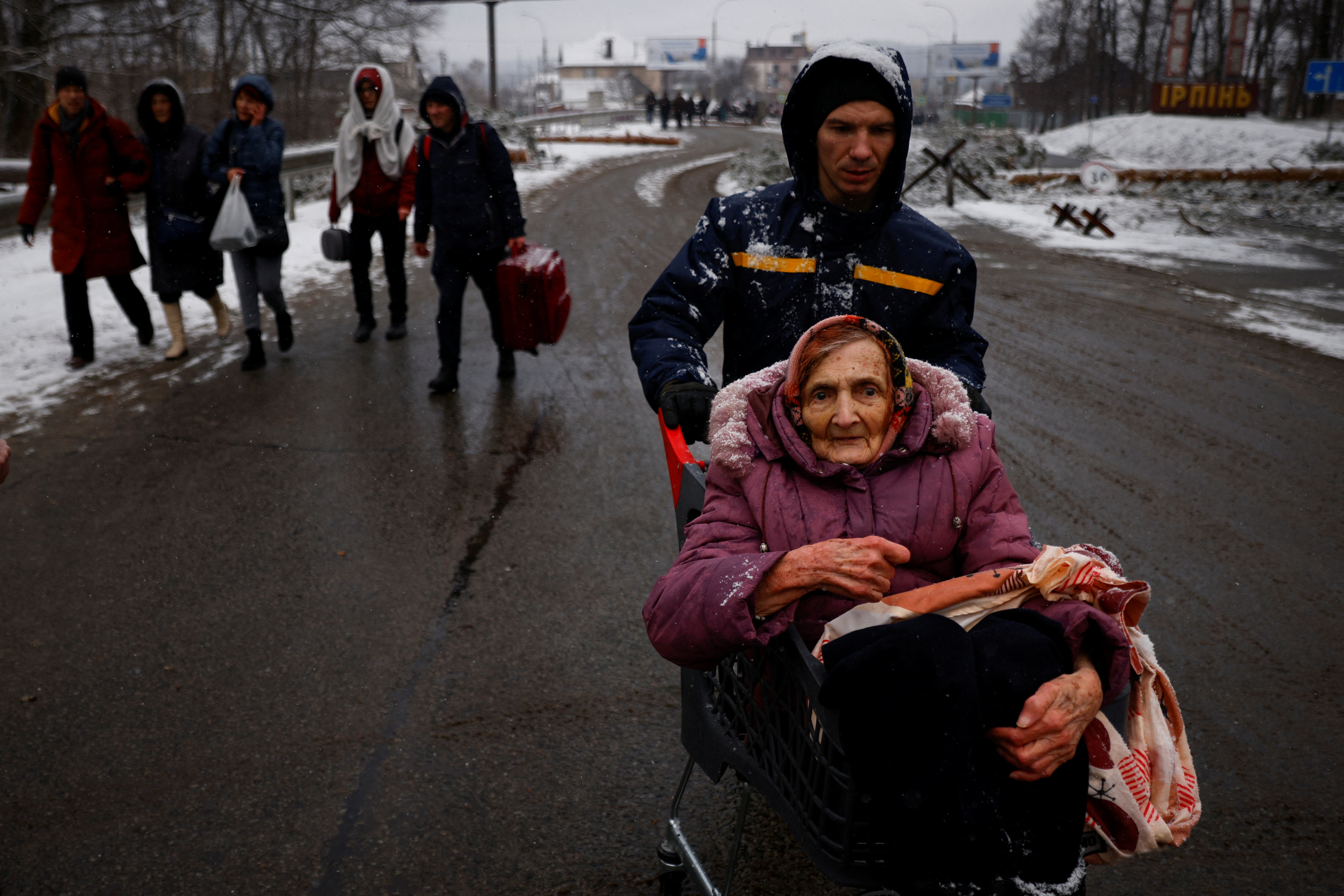 People flee from advancing Russian troops as Russia's attack on Ukraine continues in the town of Irpin outside Kyiv