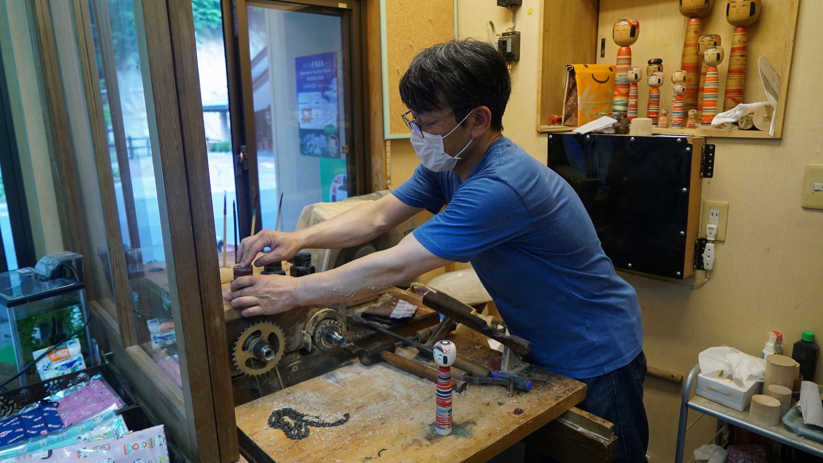 Sixth generation kokeshi maker Kunitoshi Abe cleans up after making a kokeshi at his shop in Tsuchiyu Onsen Machi