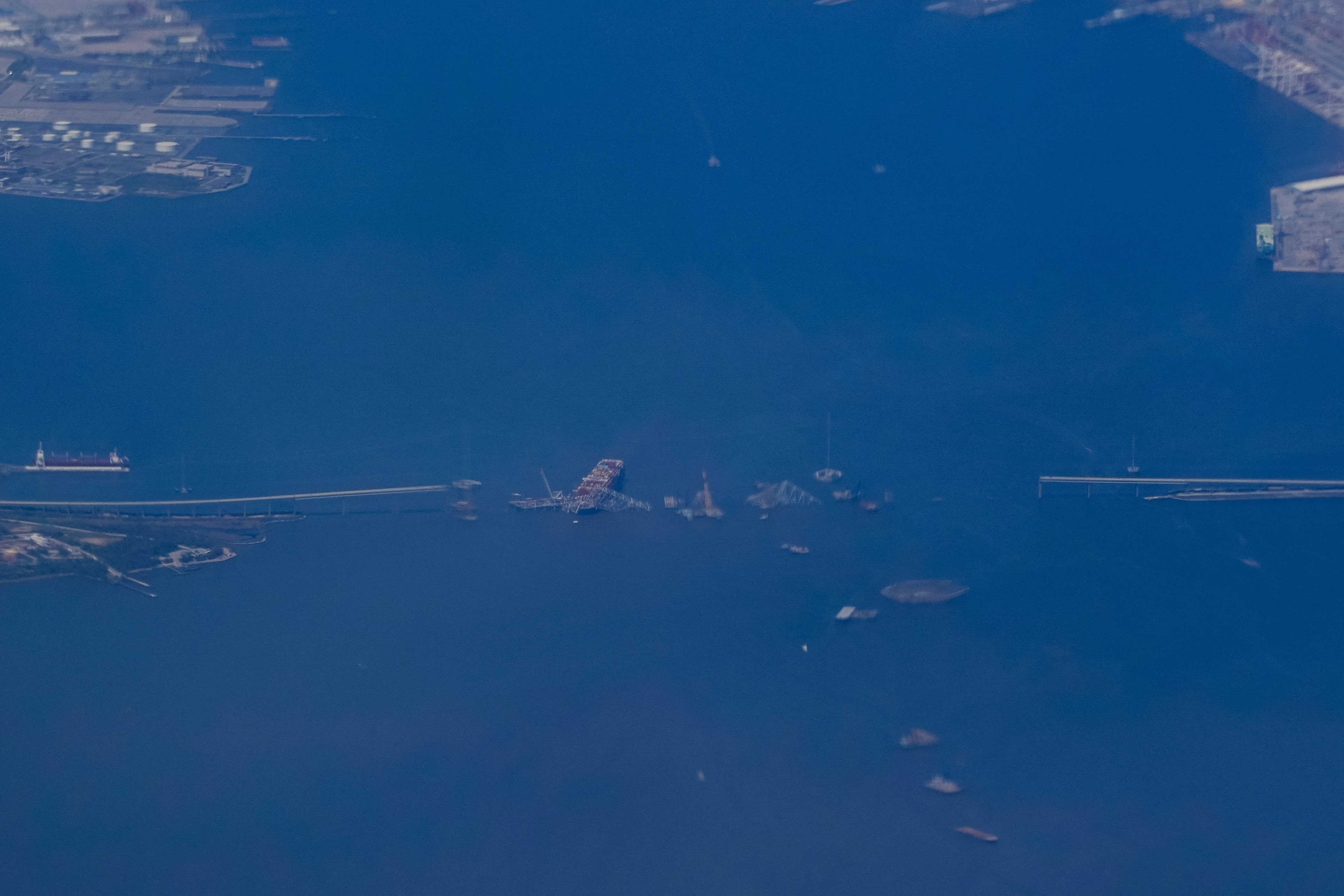 Wreckage of the collapsed Francis Scott Key Bridge and the container ship Dali are seen from Air Force One, in Baltimore