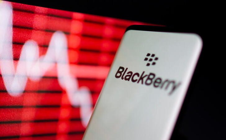 The Blackberry logo is seen on a smarphone in front of a displayed stock graph in this illustration