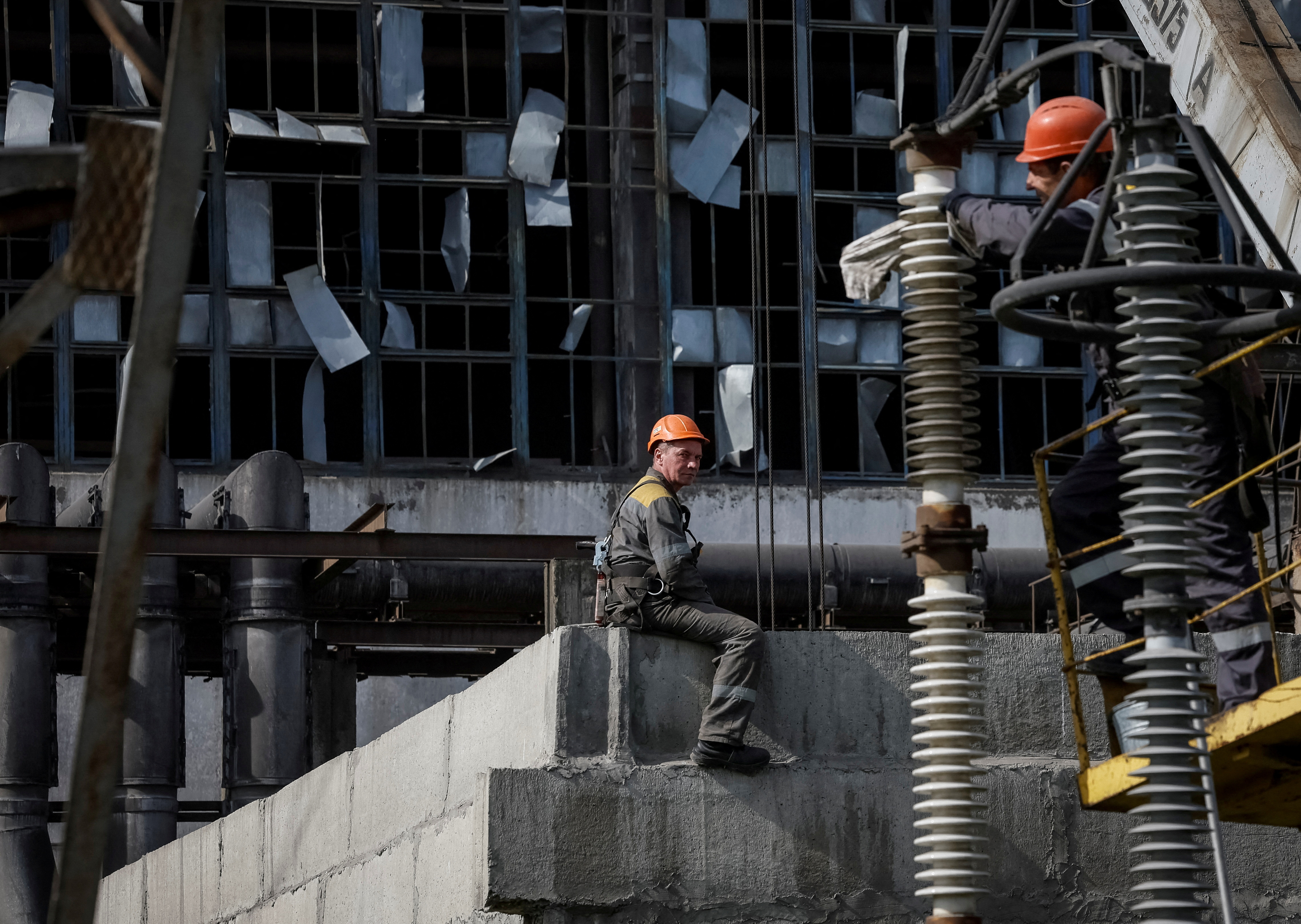 People work at a thermal power plant damaged by recent Russian missile strike