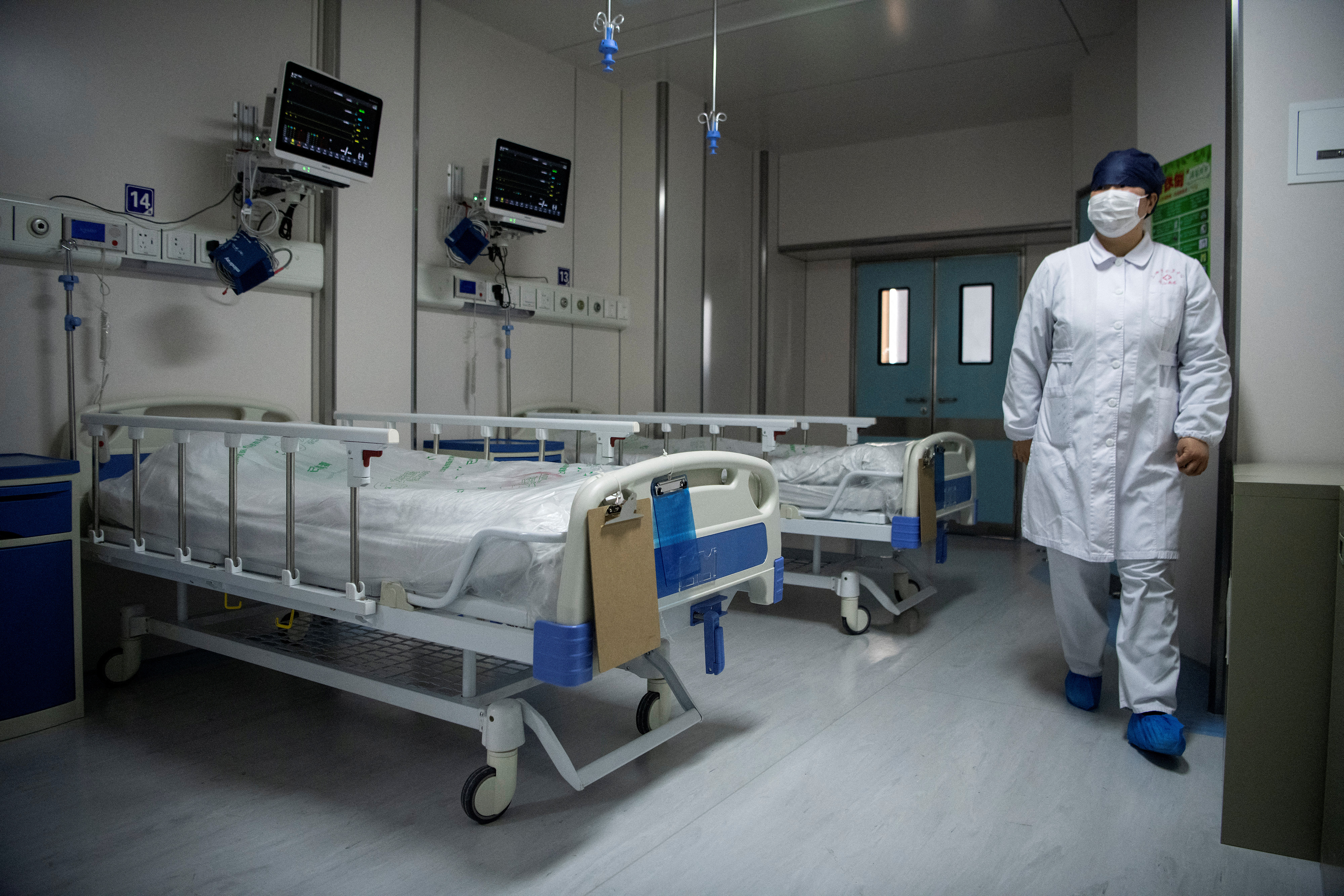 A nurse walks inside a quarantine room for coronavirus patients at finished but still unused building A2 of the Shanghai Public Clinical Center, in Shanghai