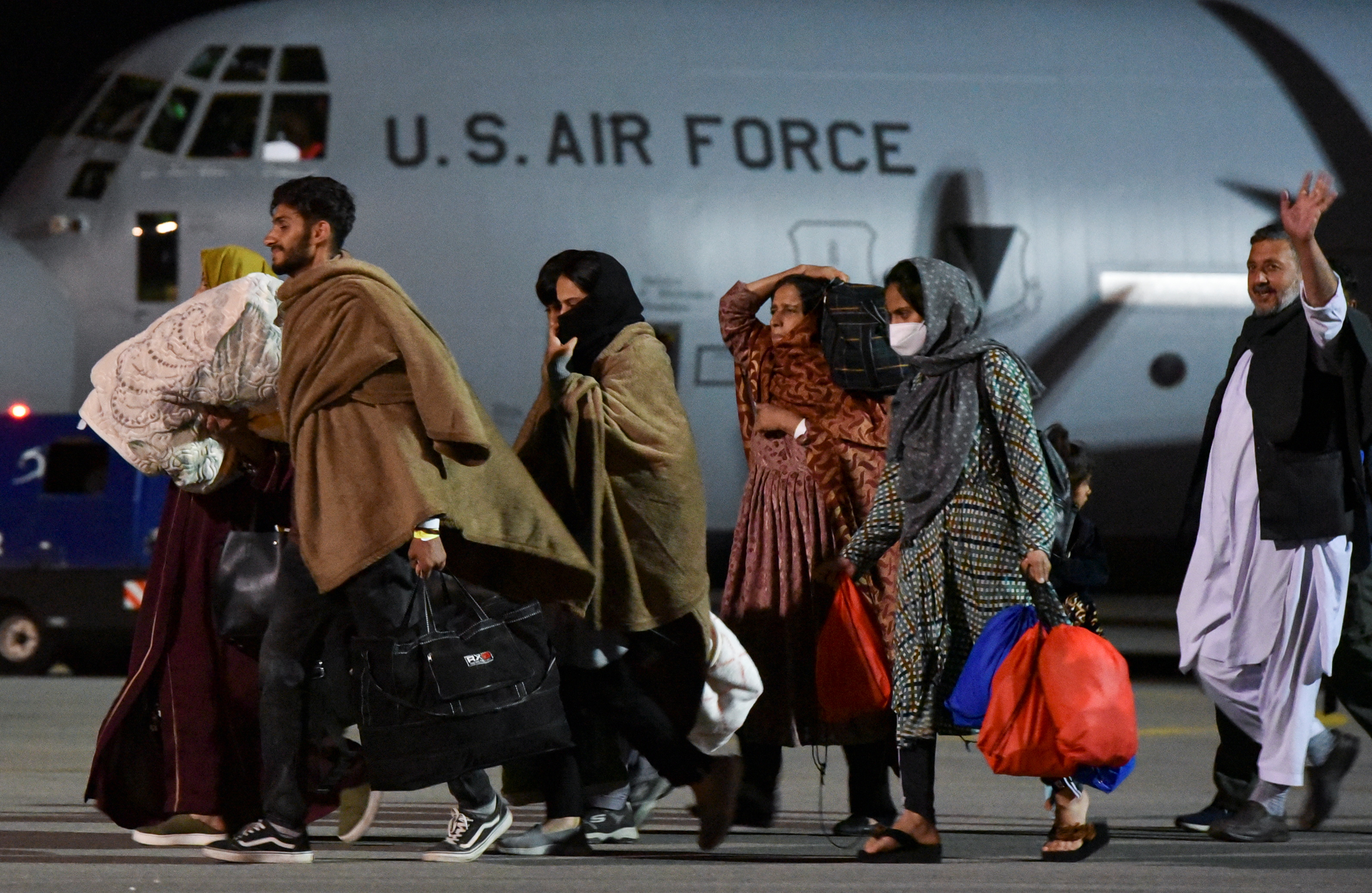 People who have been evacuated from Afghanistan arrive at Pristina International Airport in Pristina, Kosovo August 29, 2021, after Taliban insurgents entered Afghanistan's capital Kabul. REUTERS/Laura Hasani