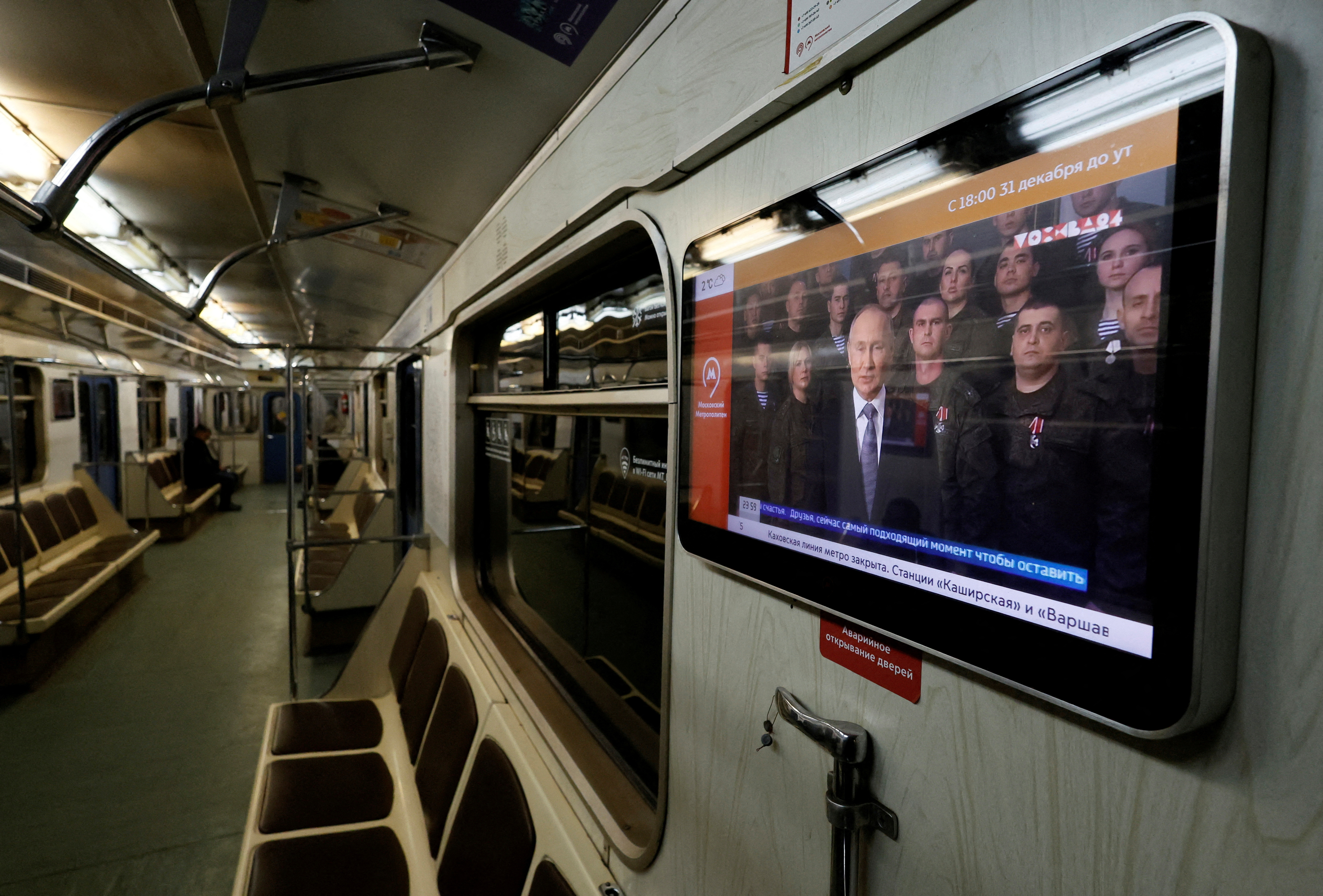 A view shows a screen broadcasting Russian President Vladimir Putin's annual New Year address to the nation, in a subway train in Moscow