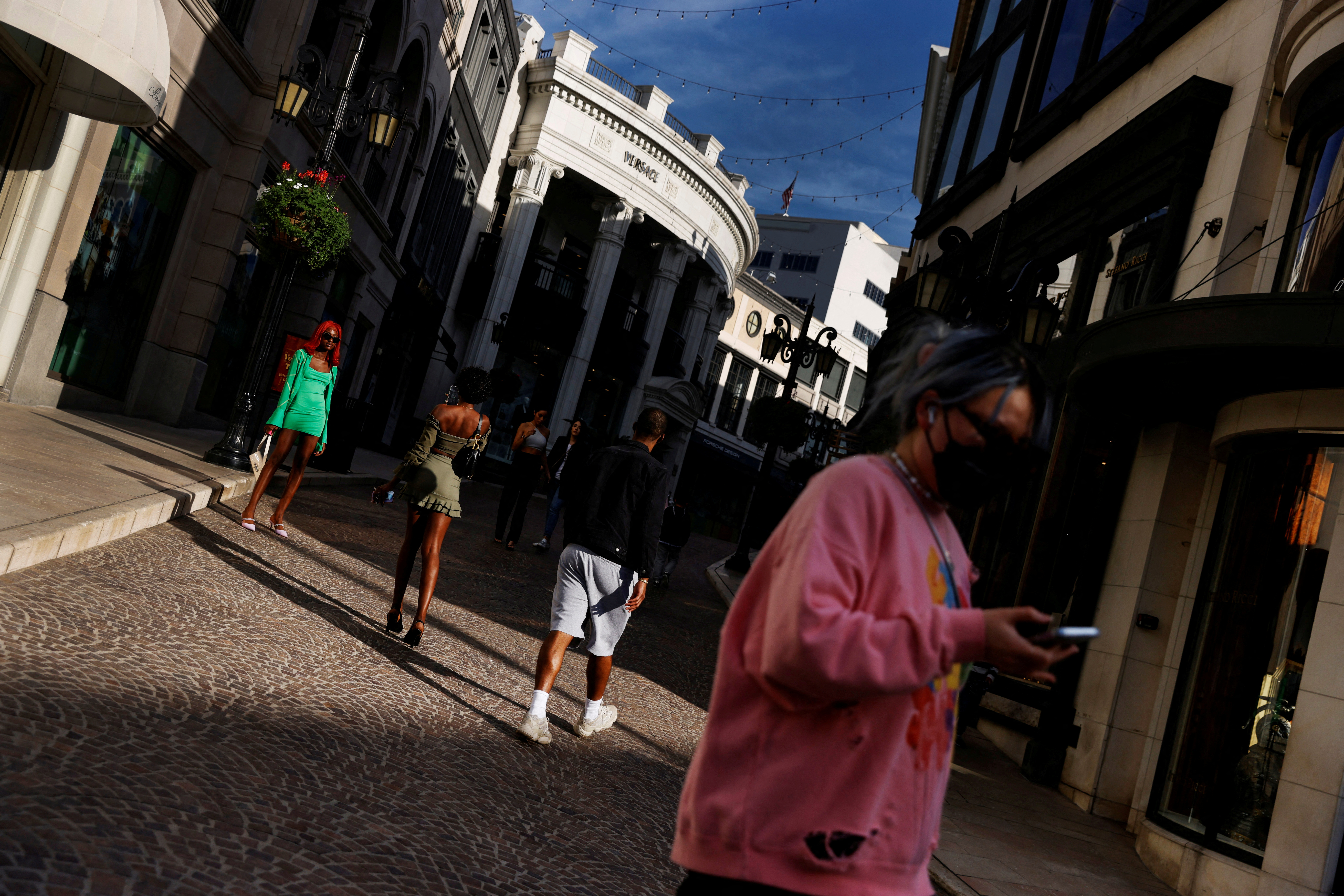 People walk at the Rodeo Drive luxury shopping area in Beverly Hills, California