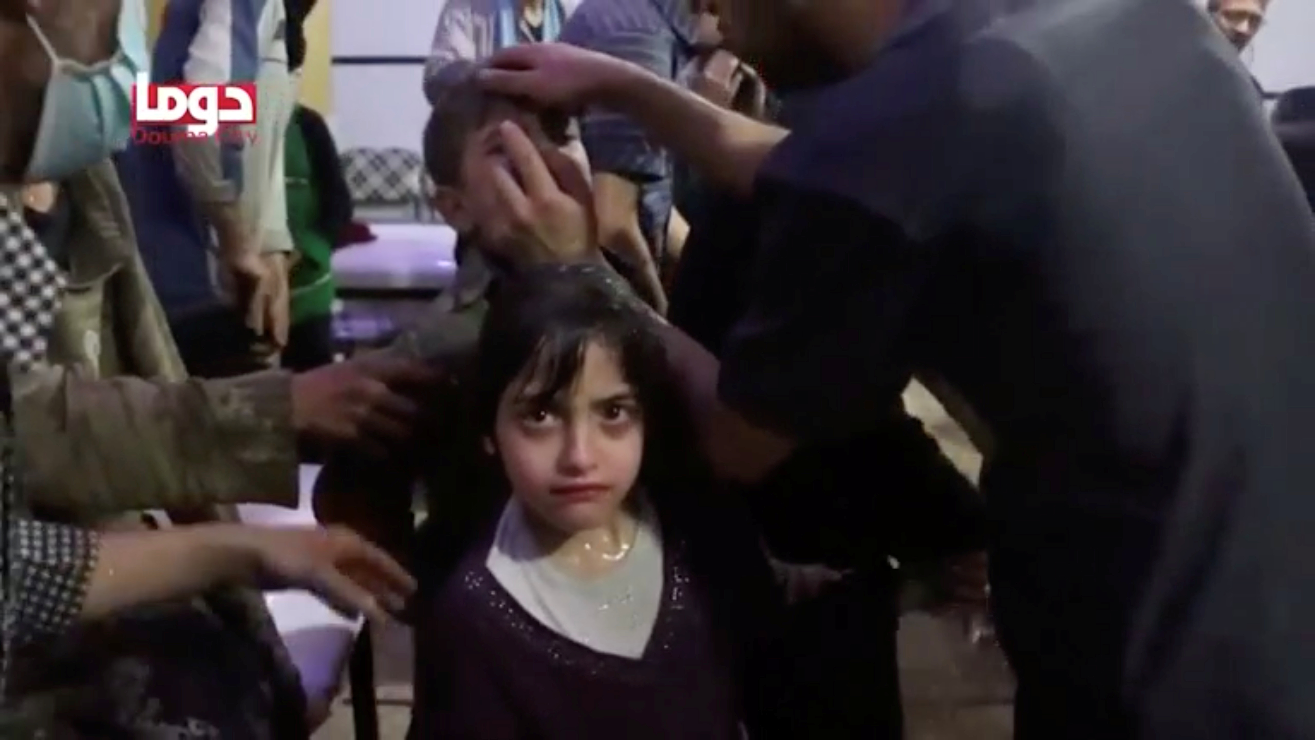 A girl looks on following alleged chemical weapons attack, in what is said to be Douma