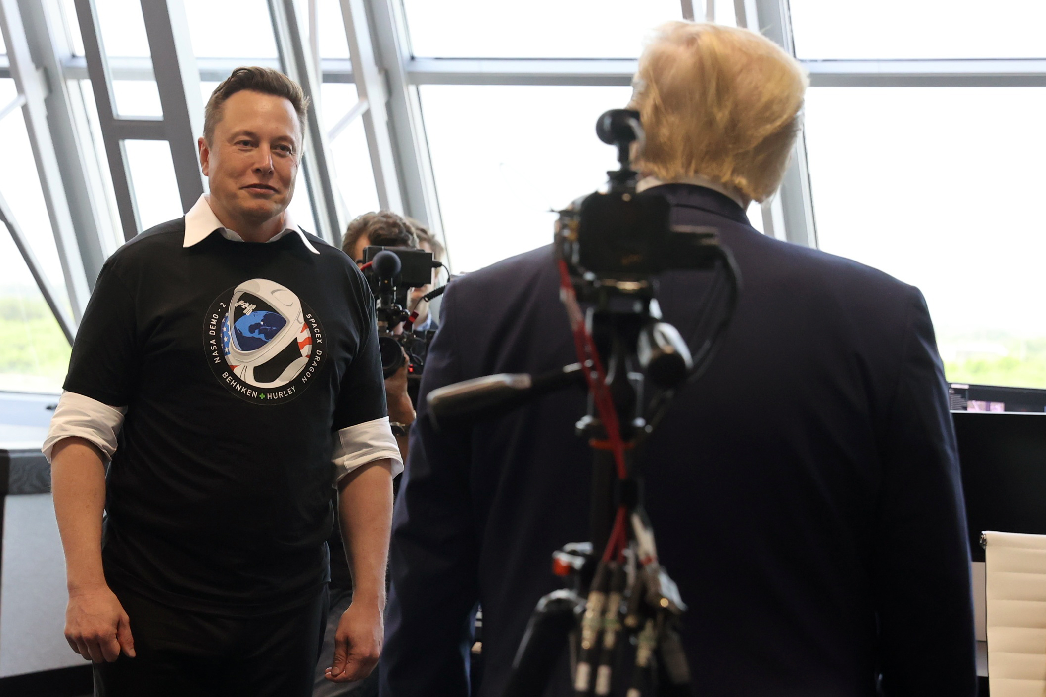 U.S. President Donald Trump and Elon Musk are seen at the Firing Room Four after the launch of a SpaceX Falcon 9 rocket and Crew Dragon spacecraft, from Cape Canaveral
