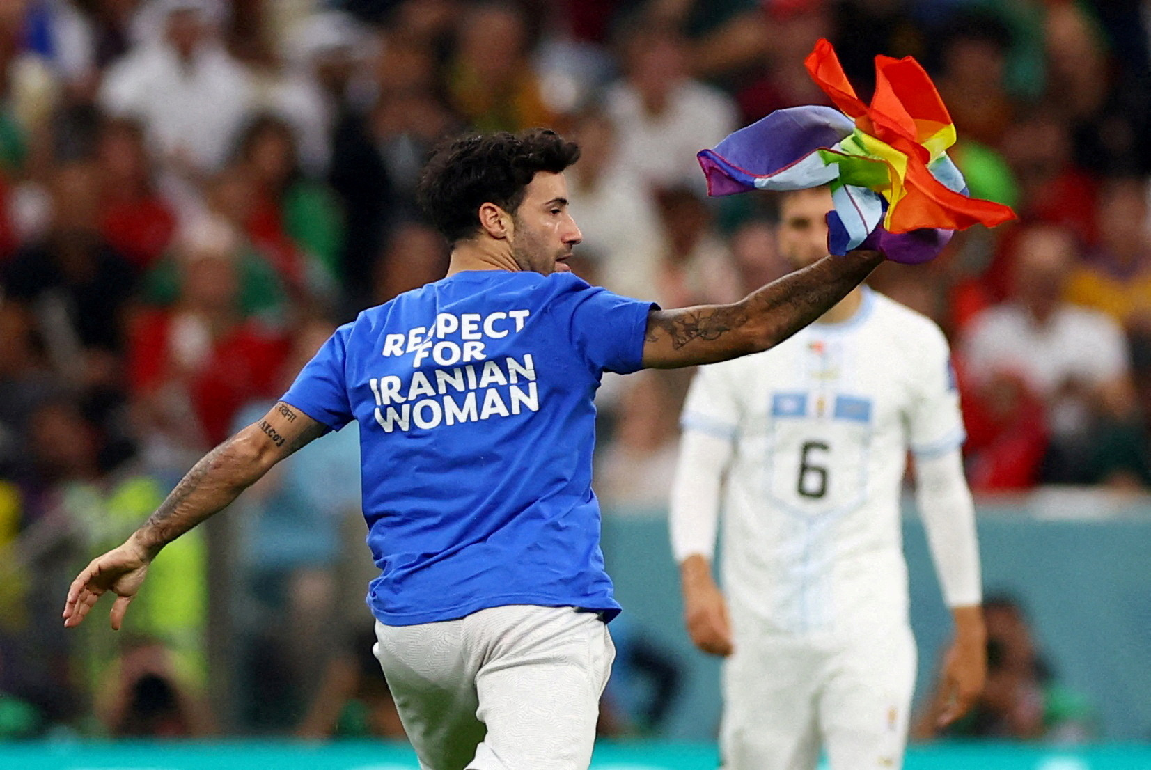 World Cup 2022 pitch invader wears 'Save Ukraine' shirt and holds pride  flag during Portugal vs Uruguay