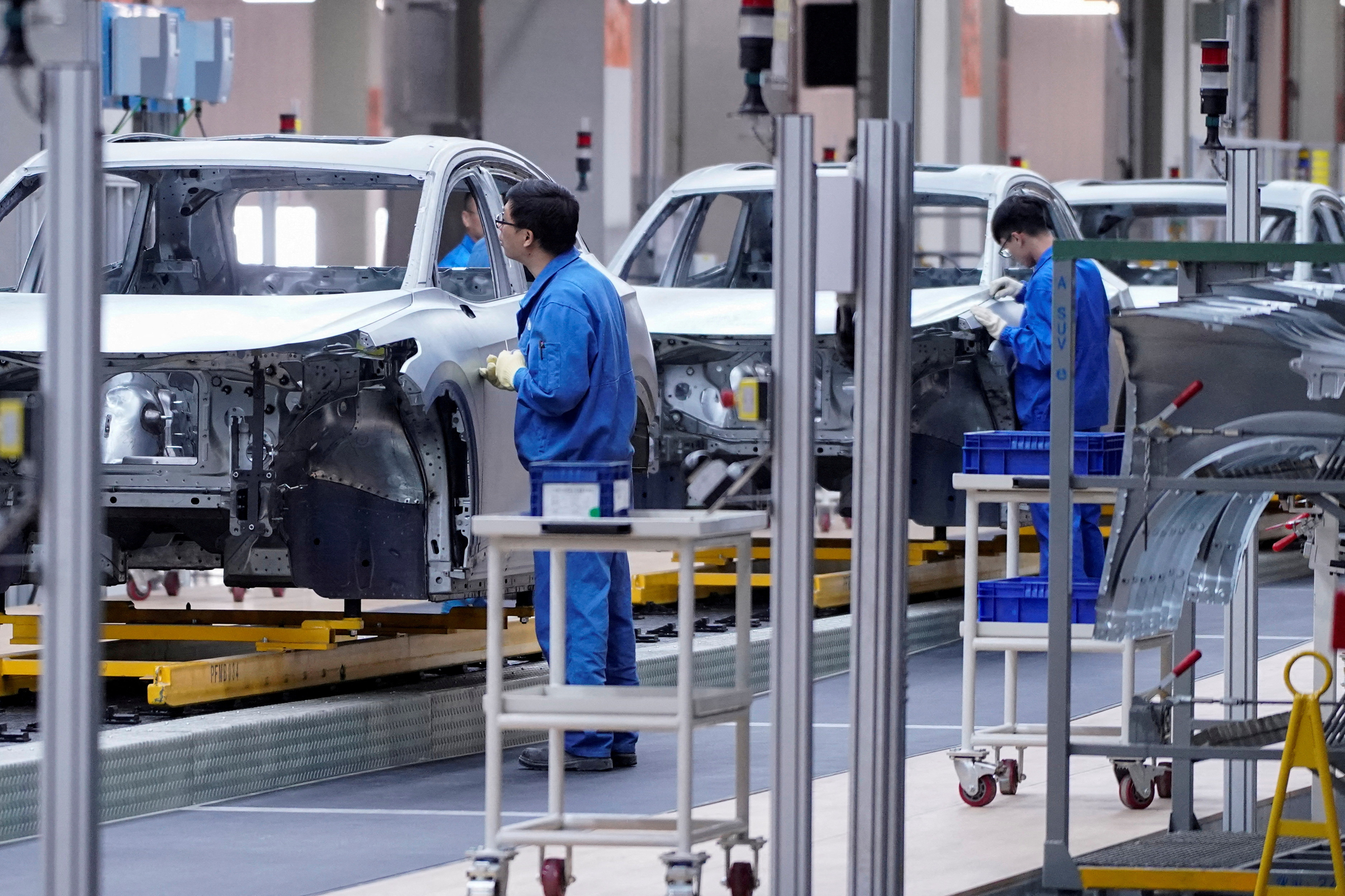 Employees work on assembly line of SAIC Volkswagen MEB electric vehicle plant in Shanghai