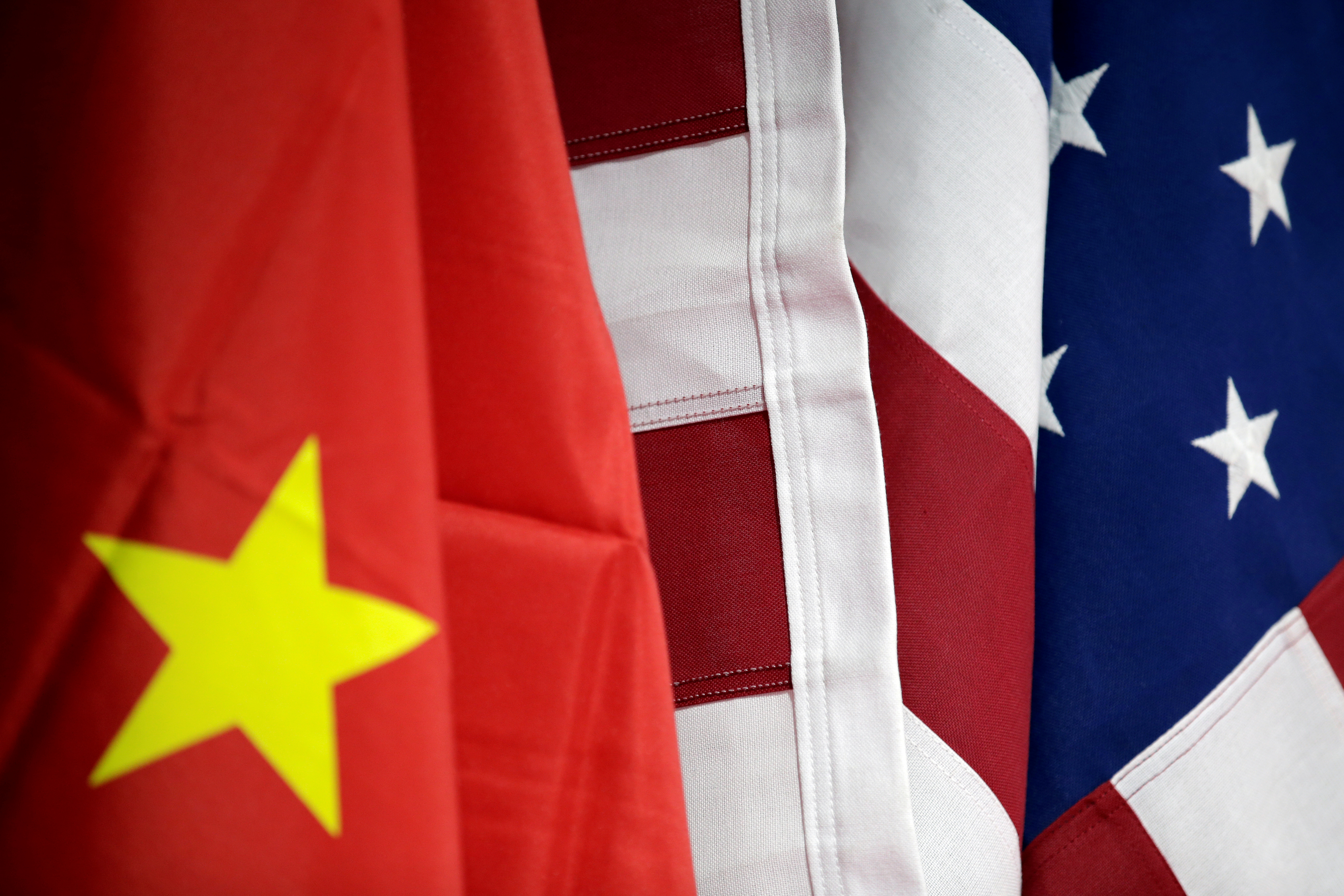 Flags of U.S. and China are displayed at American International Chamber of Commerce (AICC)'s booth during China International Fair for Trade in Services in Beijing, China, May 28, 2019. REUTERS/Jason Lee