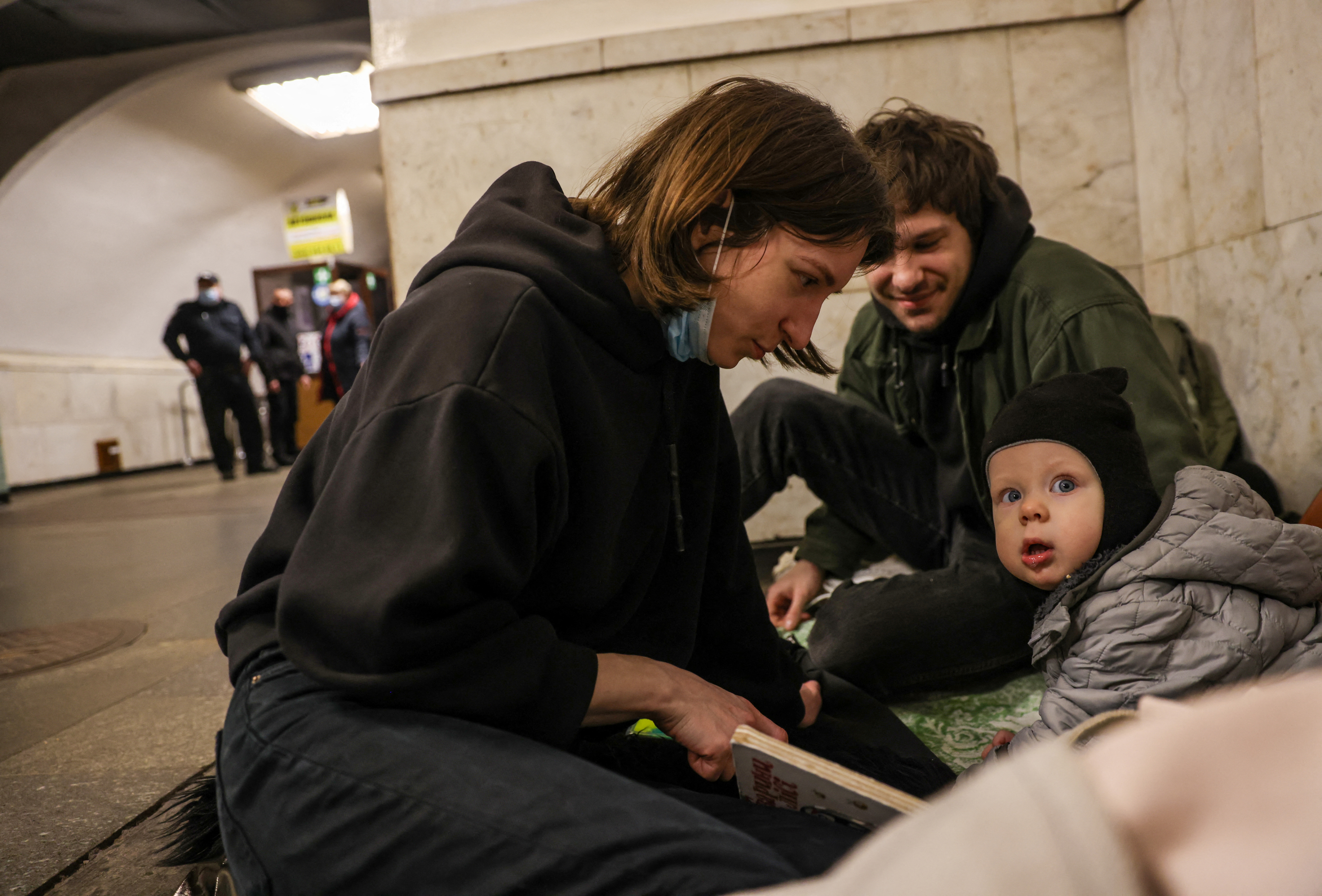 People gather at a metro station as they seek shelter from expected Russian air strikes, in Kyiv