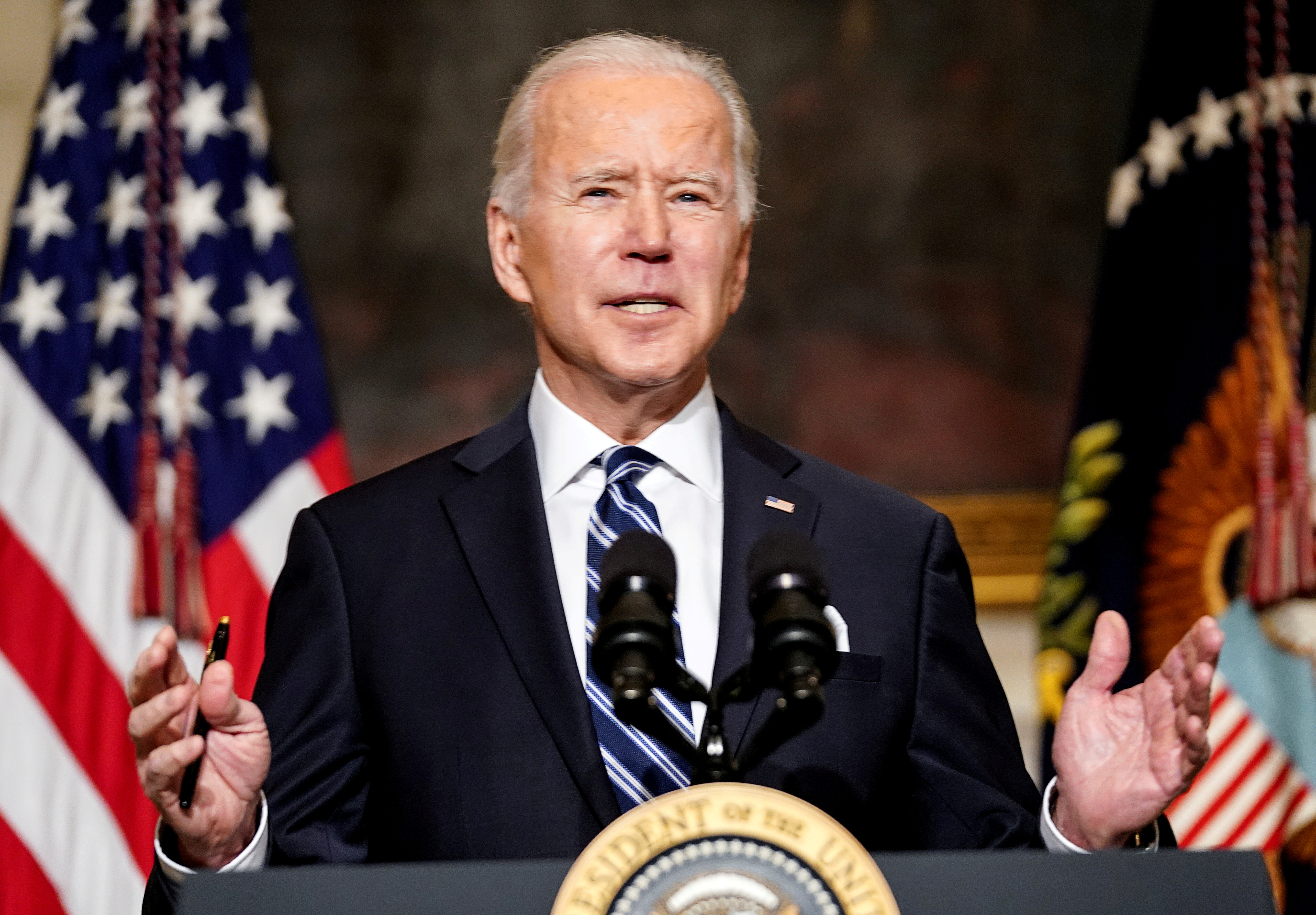 U.S. President Joe Biden delivers remarks on tackling climate change prior to signing executive actions in the State Dining Room at the White House in Washington, U.S., January 27, 2021. REUTERS/Kevin Lamarque/File Photo