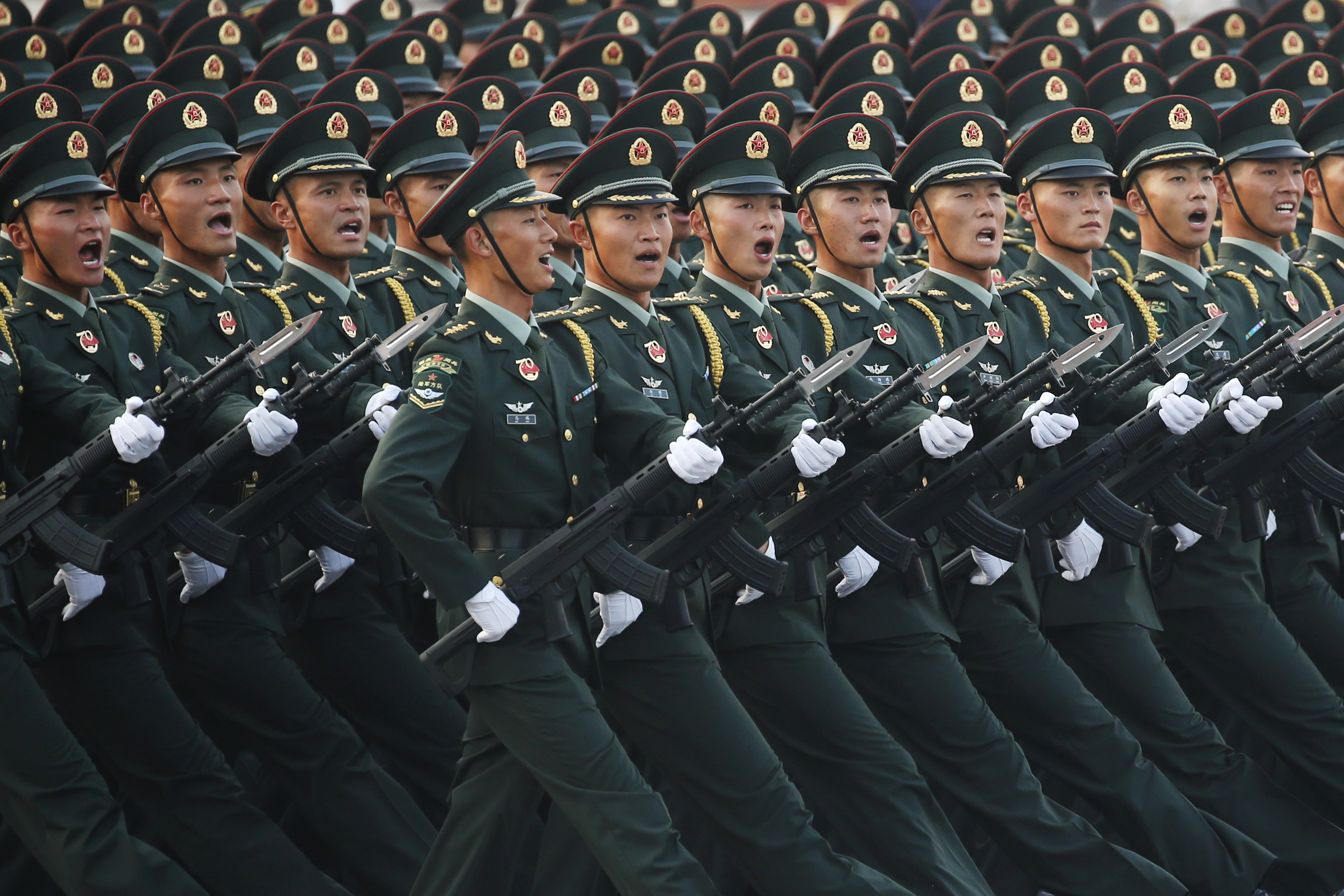 Soldiers of People's Liberation Army (PLA) march in formation past Tiananmen Square during a rehearsal before a military parade marking the 70th founding anniversary of People's Republic of China