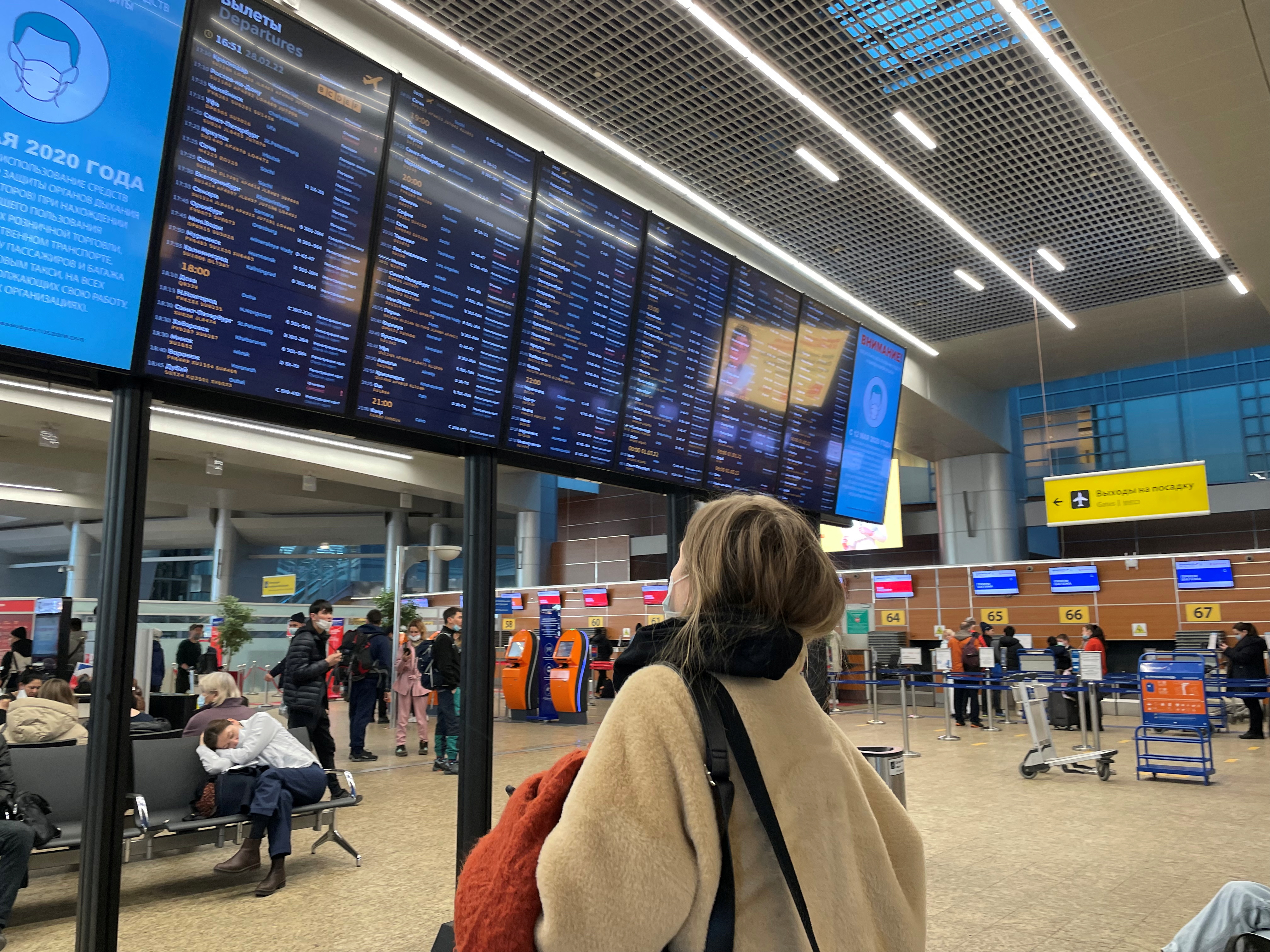 A passenger looks at a departures board at Sheremetyevo airport in Moscow